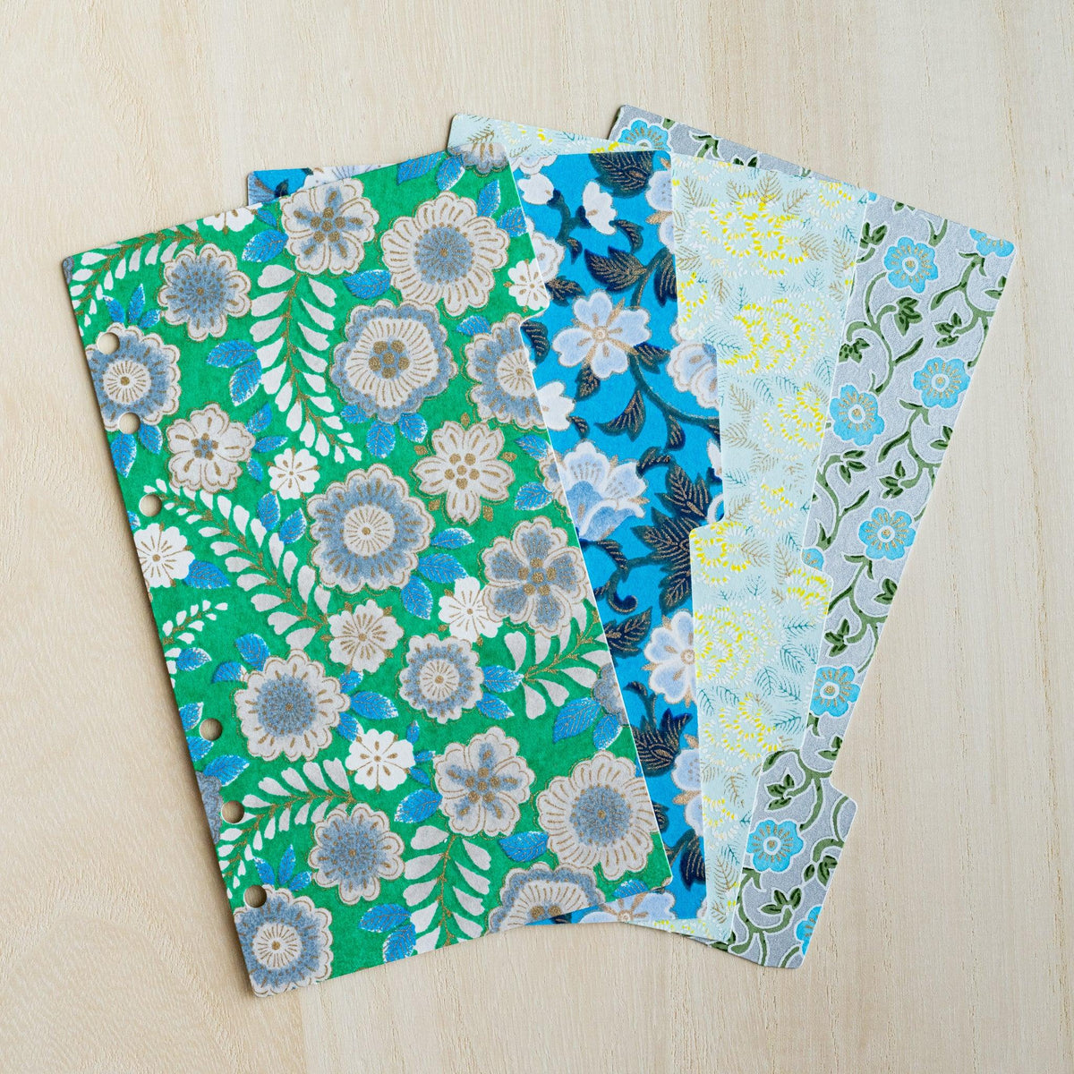 Four Garden Yuzen washi index dividers for Bible size planners fanned out, green, blue and pale floral prints