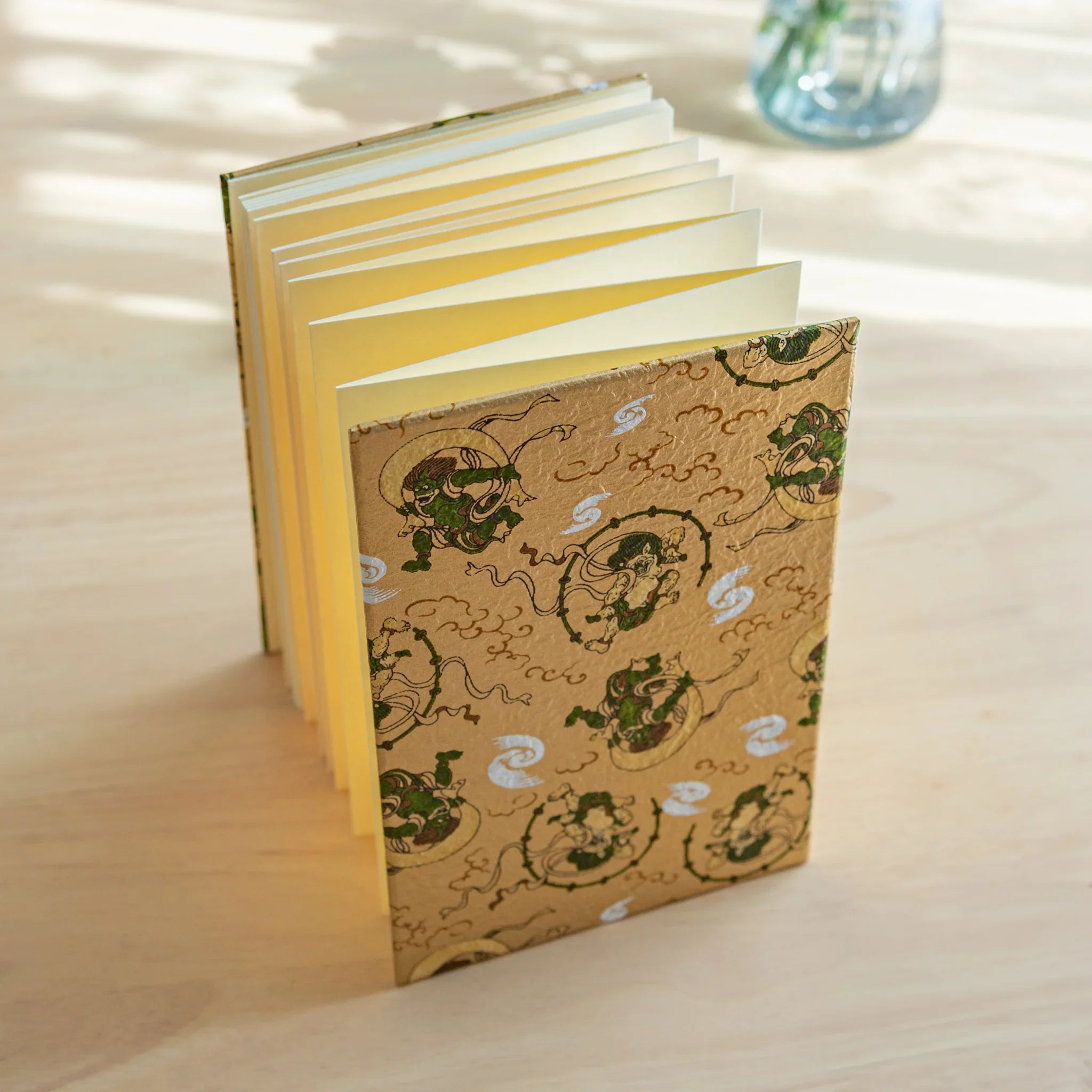 Wind and Thunder Goshuincho opened showing blue washi interior and traditional pattern design displayed clearly