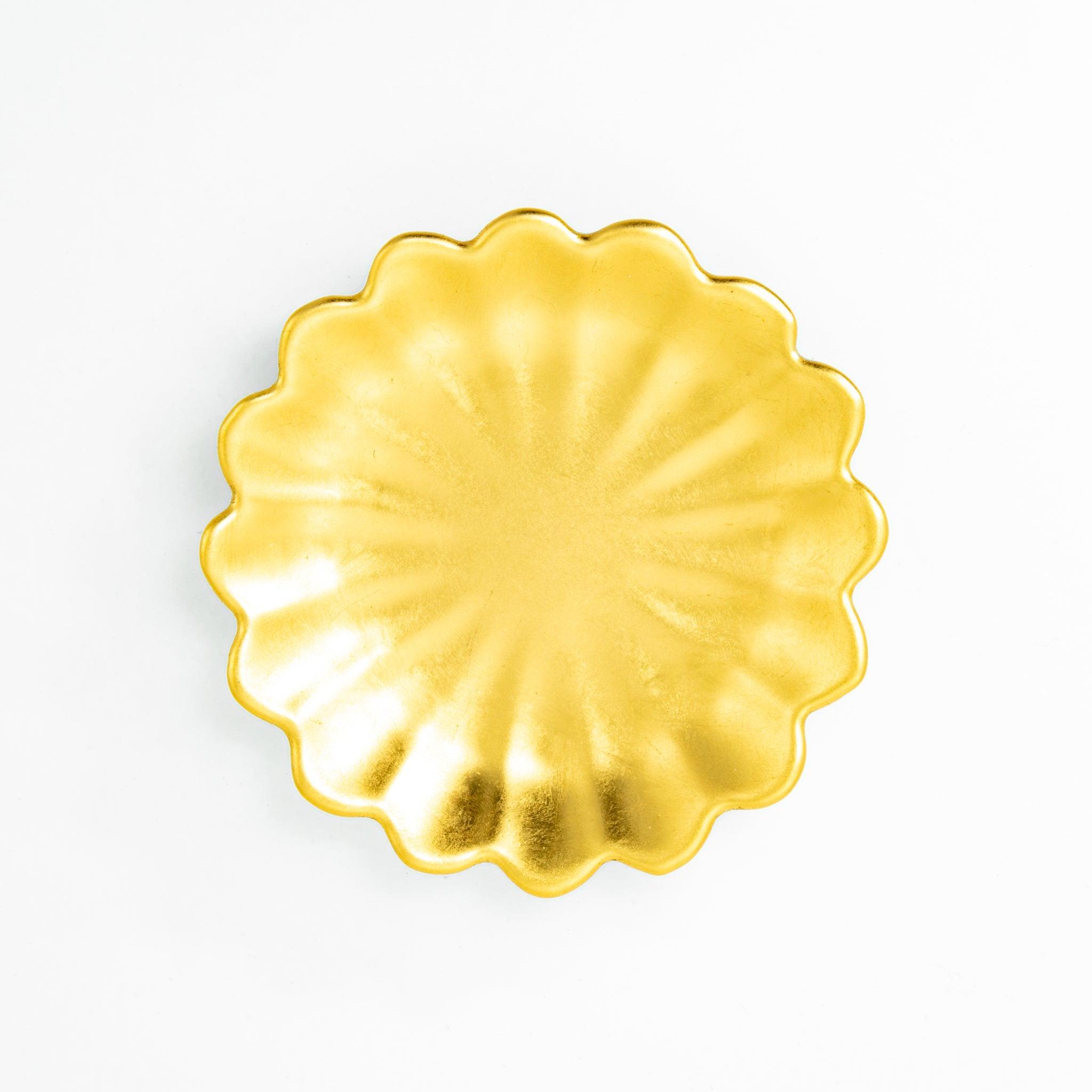 A scalloped gold ceramic pen rest for Japanese stationery, shown in a side profile on a white background.