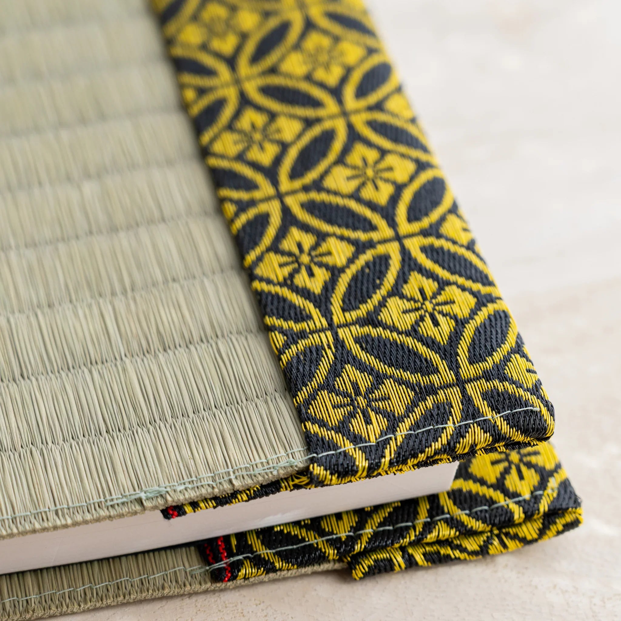Close-up of folded fabric flap on Gold Shippo tatami book cover showing Japanese shippo circle pattern and stitching