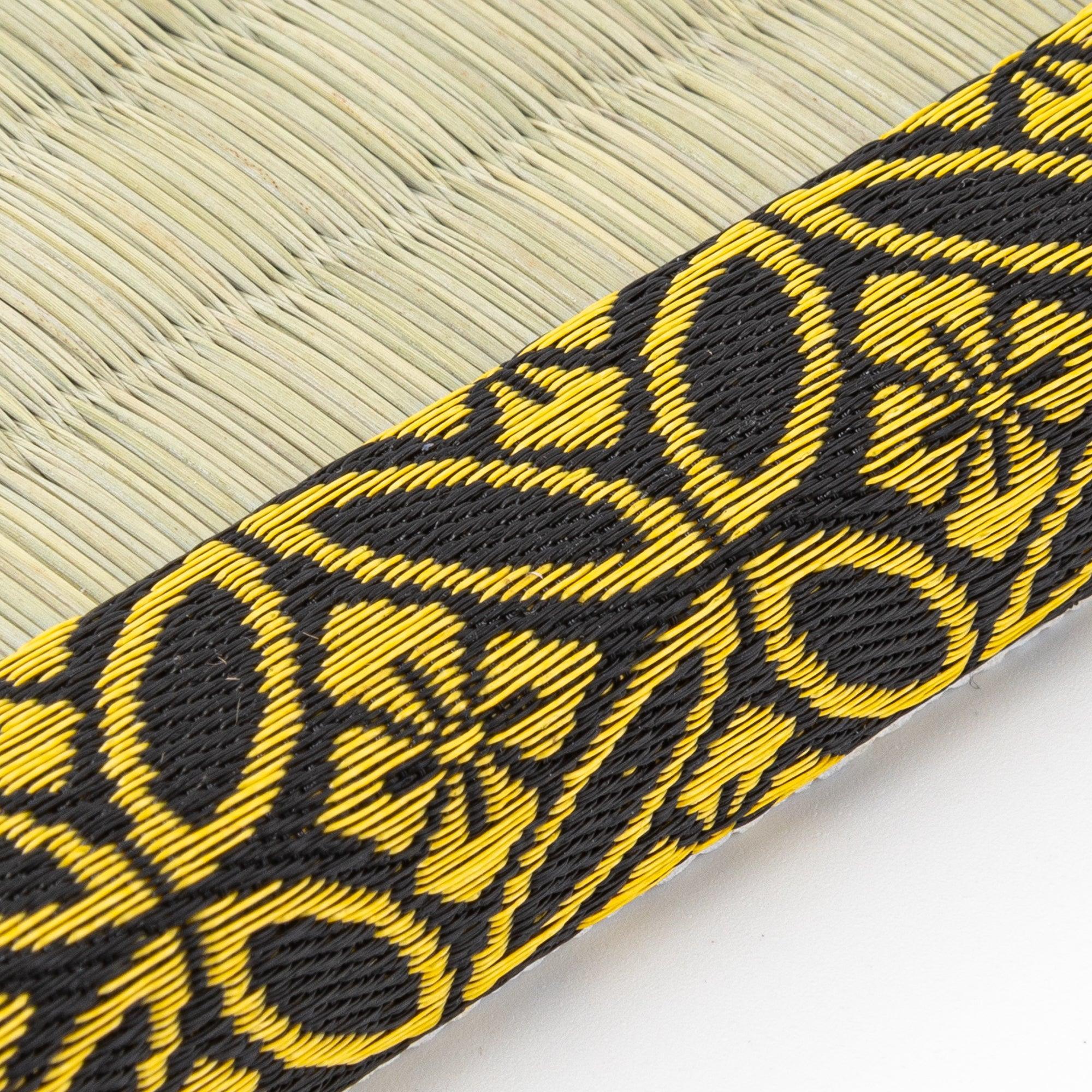 Japanese tatami pen tray with black and gold-patterned edges, showcasing its elegant woven design.