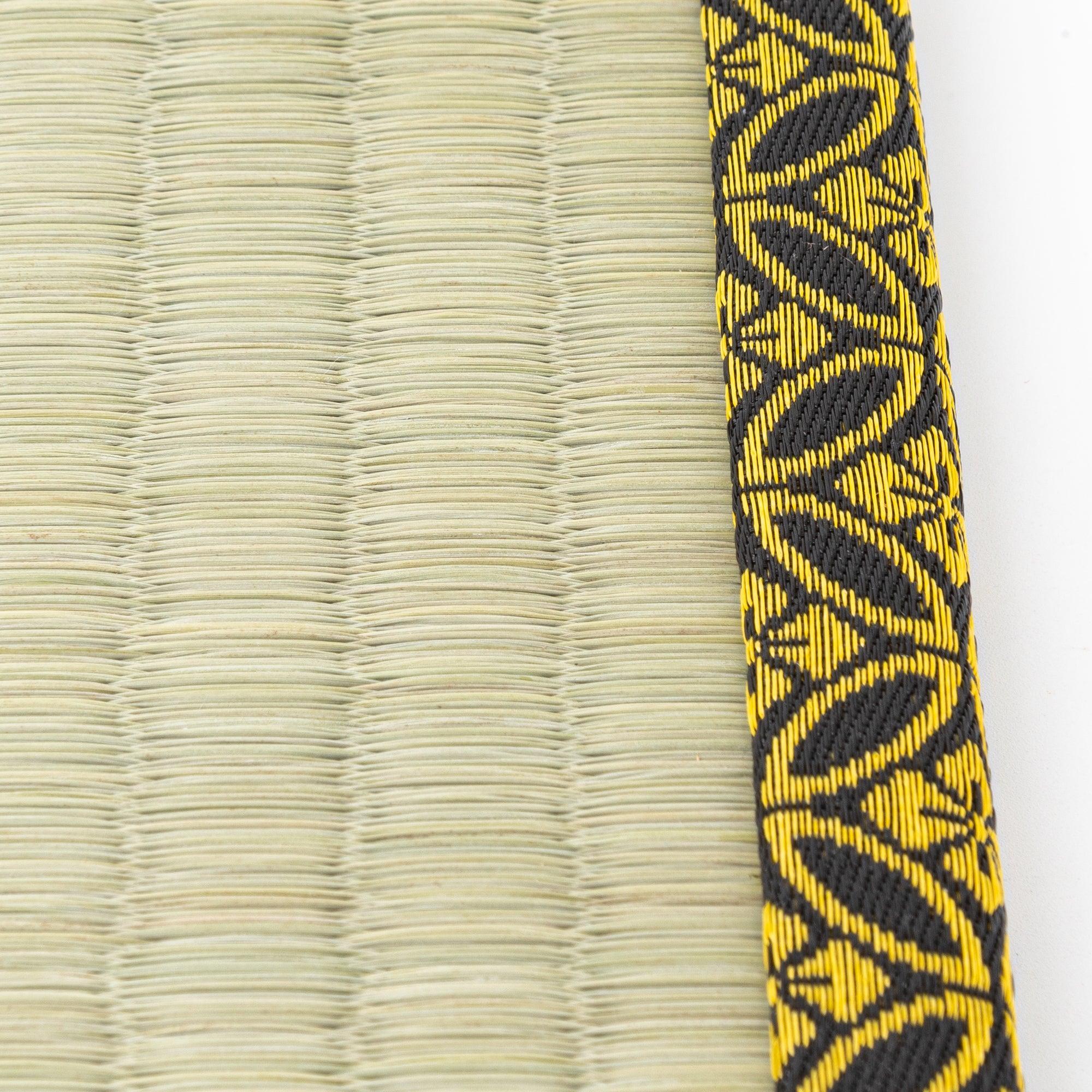 Japanese tatami pen tray with black and gold-patterned edges, showcasing its elegant woven design.