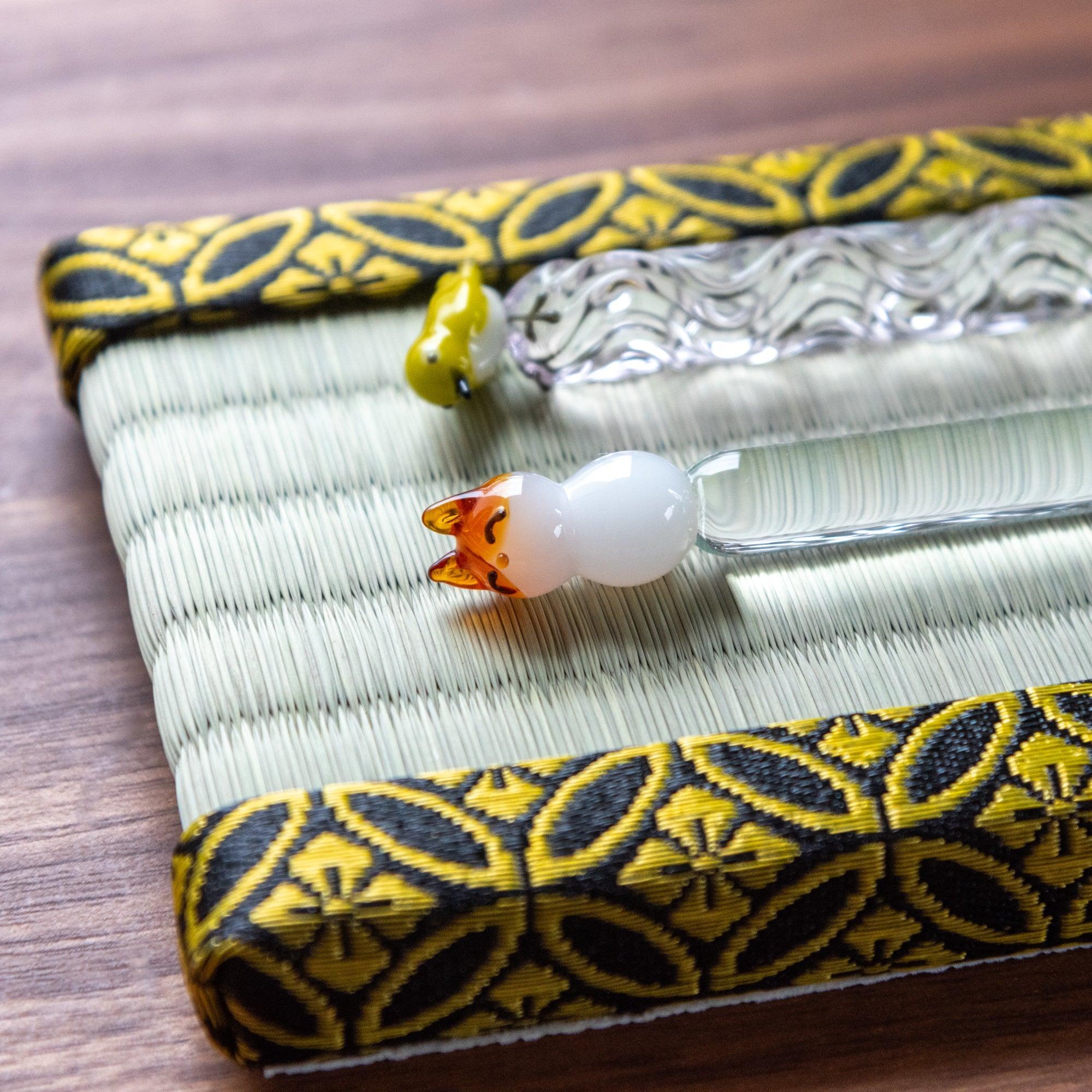 Top flat view of woven tatami tray with gold geometric shippo pattern edge embellishment detail visible