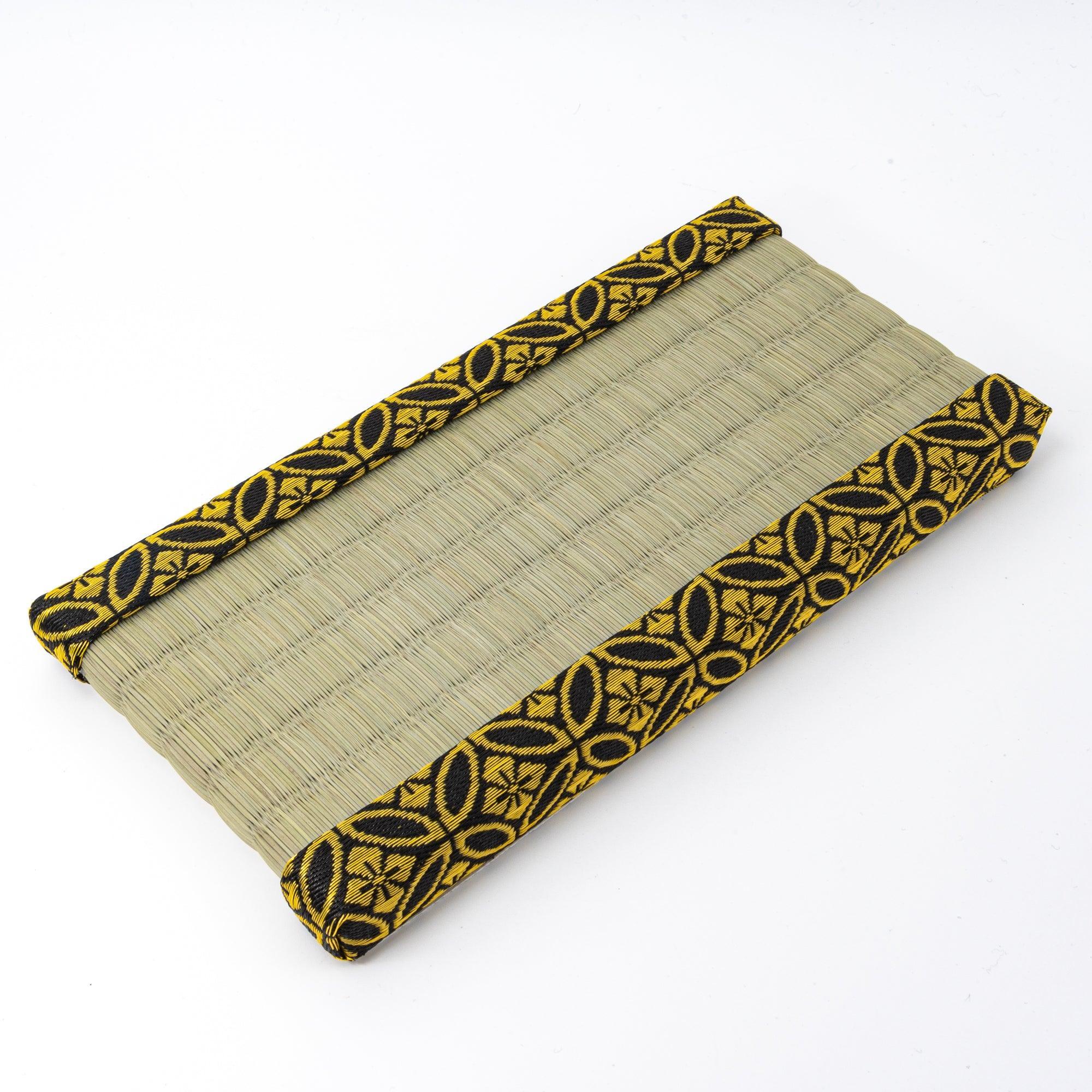 Japanese tatami pen tray with black and gold-patterned edges, showcasing its elegant woven design.
