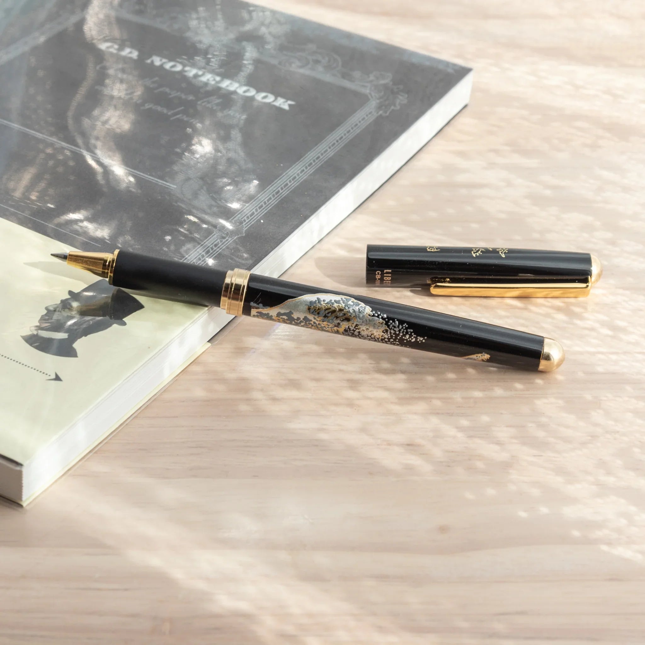 Capped-off Japanese Ballpoint Pen with Lacquer finish, featuring great wave design on a black glossy body.