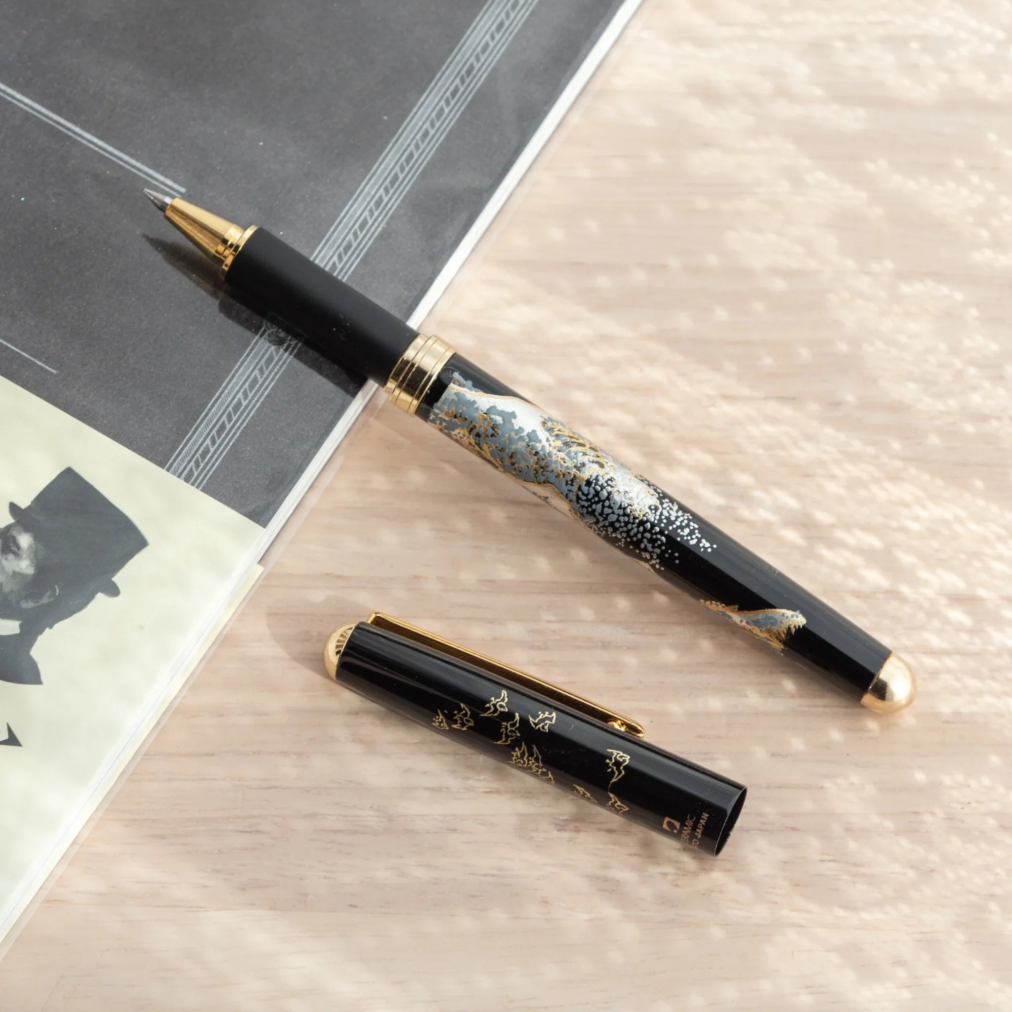 Capped-off Japanese Ballpoint Pen with Lacquer finish, featuring great wave design on a black glossy body.