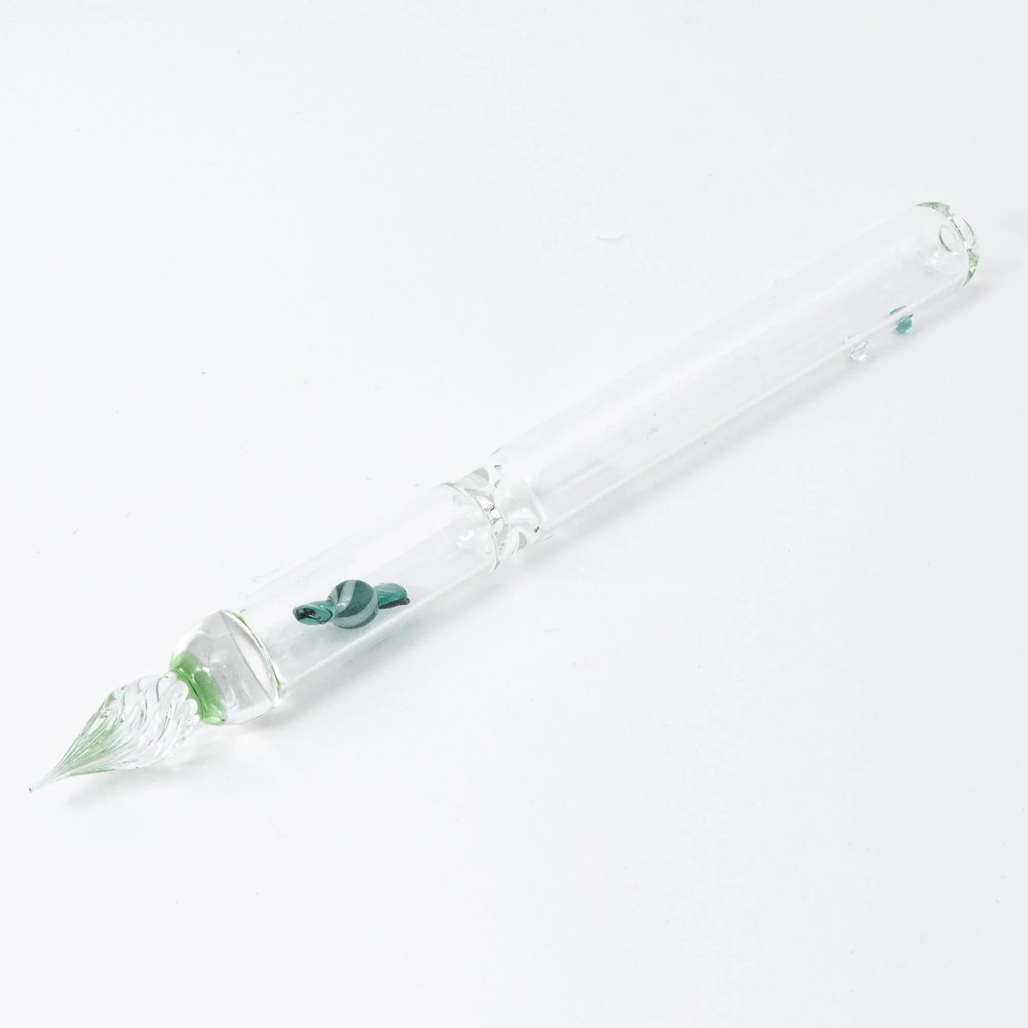 Top view of green glass dip pen featuring multiple captured candy elements and hand-twisted glass nib with holder