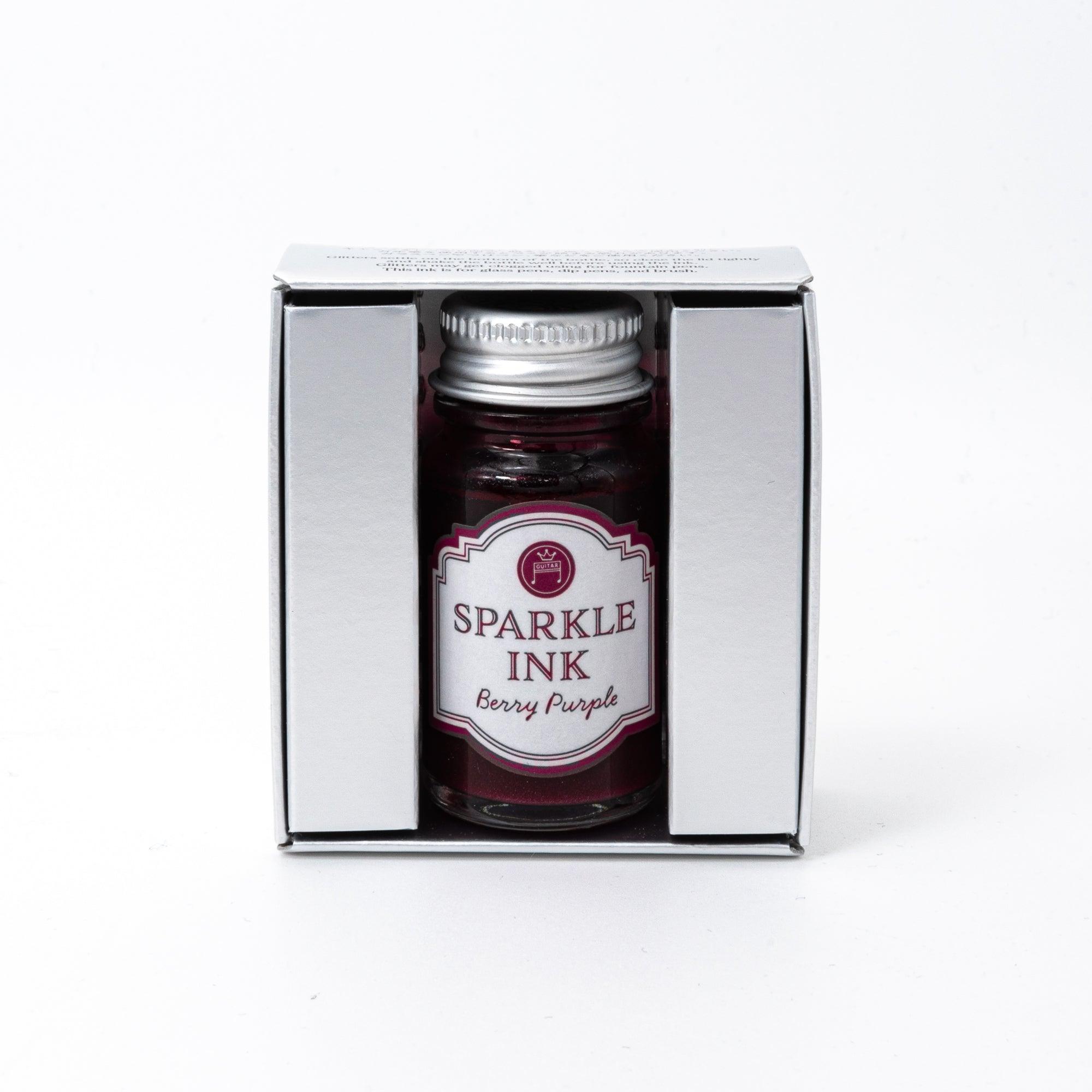 Sparkle Ink in Berry Purple, displayed in a glass bottle with matching berry-colored packaging featuring floral patterns and elegant lettering.
