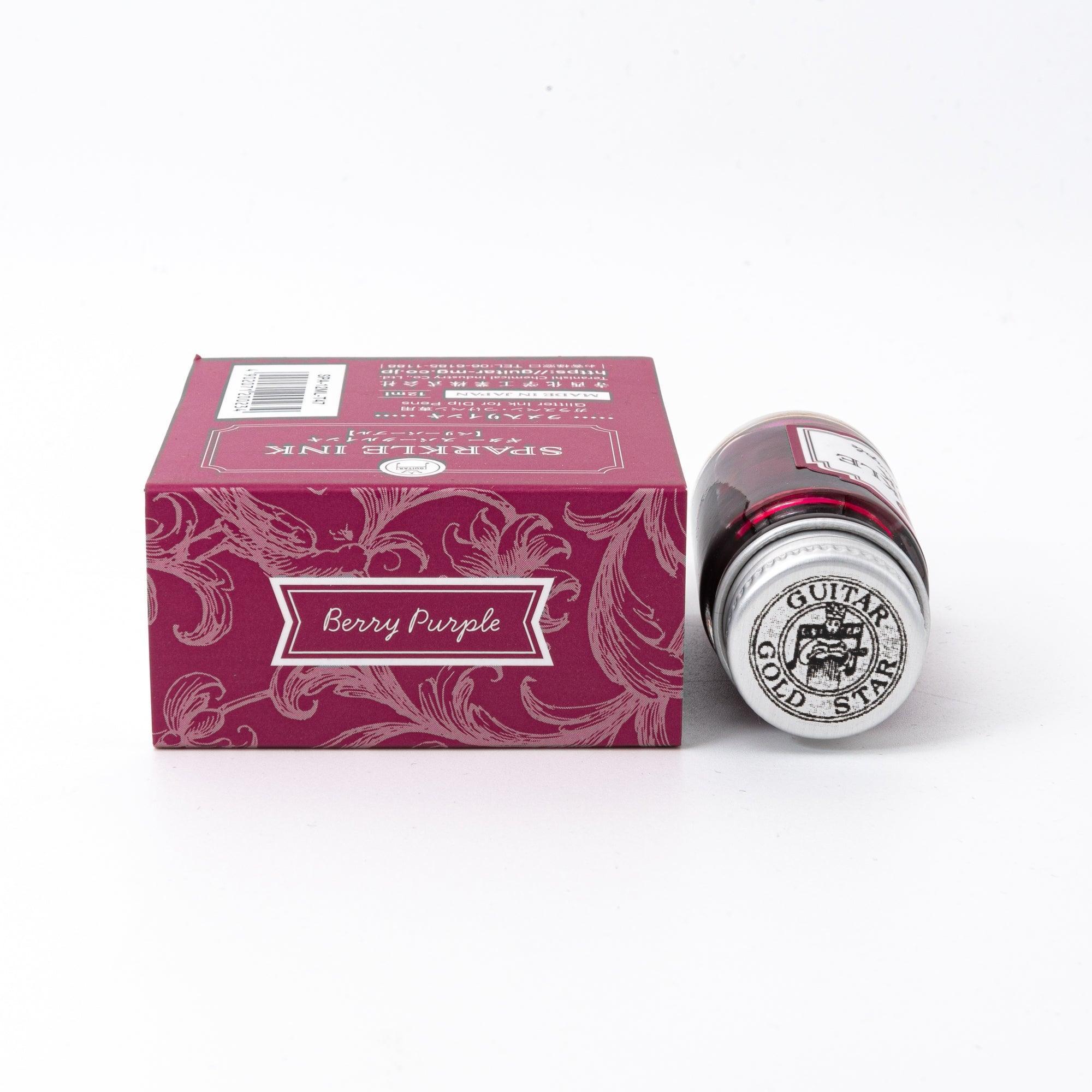 Sparkle Ink in Berry Purple, displayed in a glass bottle with matching berry-colored packaging featuring floral patterns and elegant lettering.