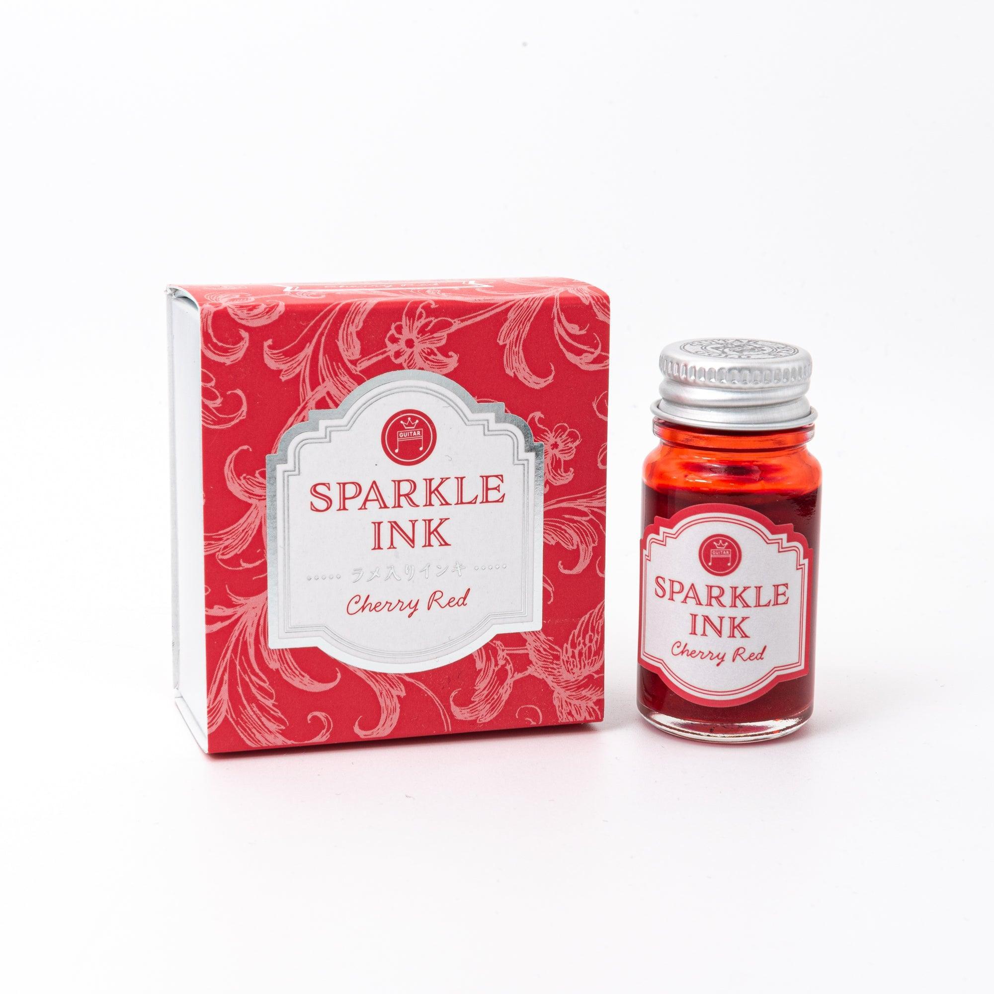 A bottle of Sparkle Ink in Cherry Red, accompanied by its matching red decorative box, adorned with intricate floral patterns.