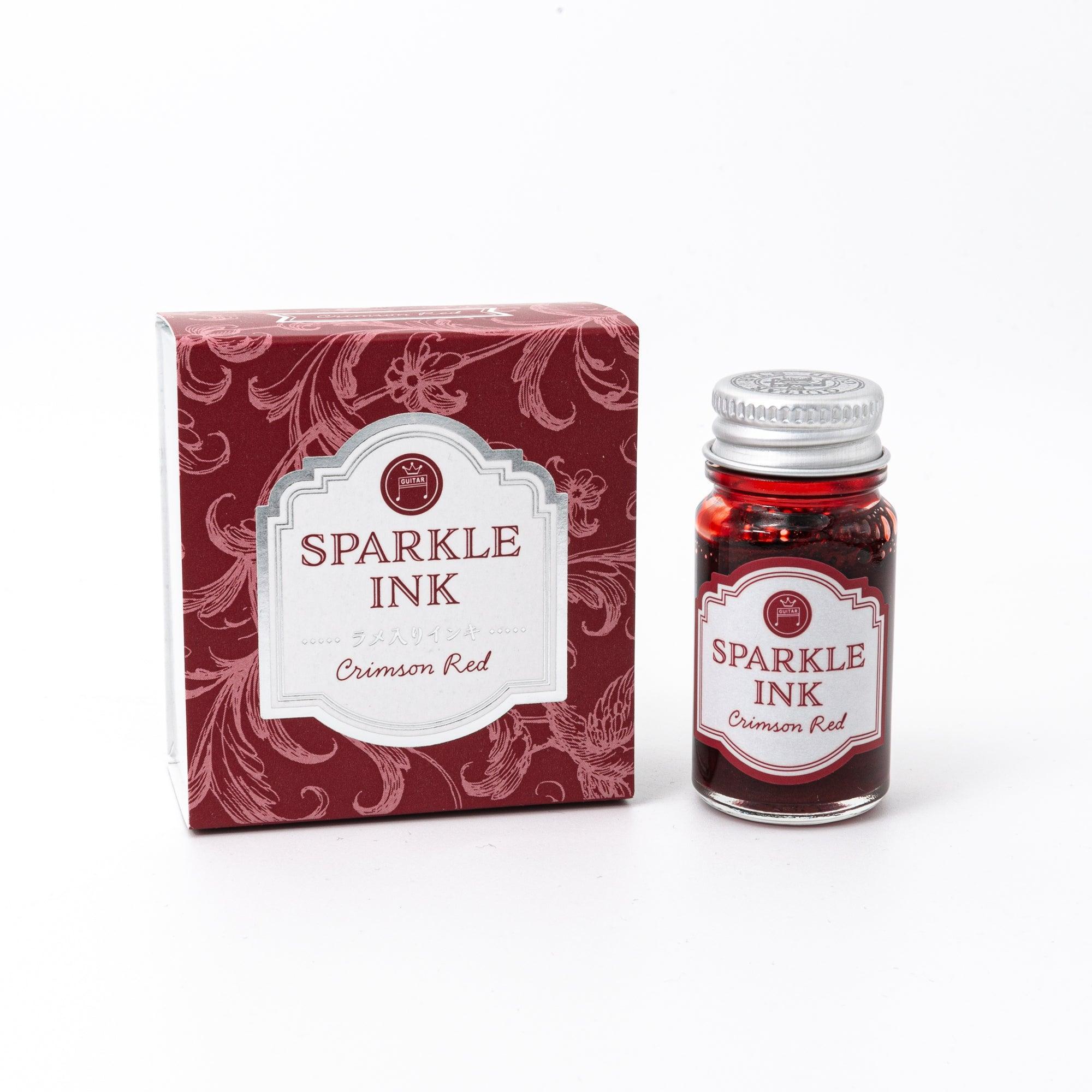 Sparkle Ink in Crimson Red, presented in a glass bottle with matching red packaging adorned with intricate floral patterns and elegant text.