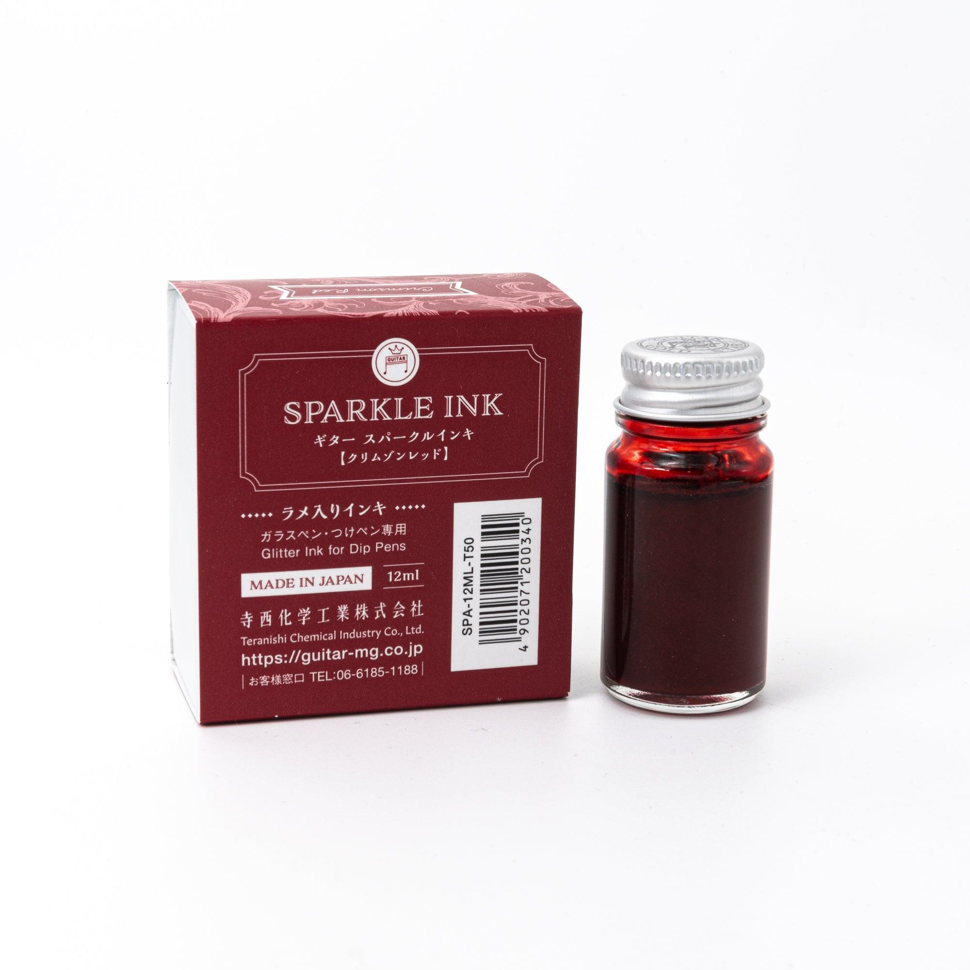 Sparkle Ink in Crimson Red, presented in a glass bottle with matching red packaging adorned with intricate floral patterns and elegant text.