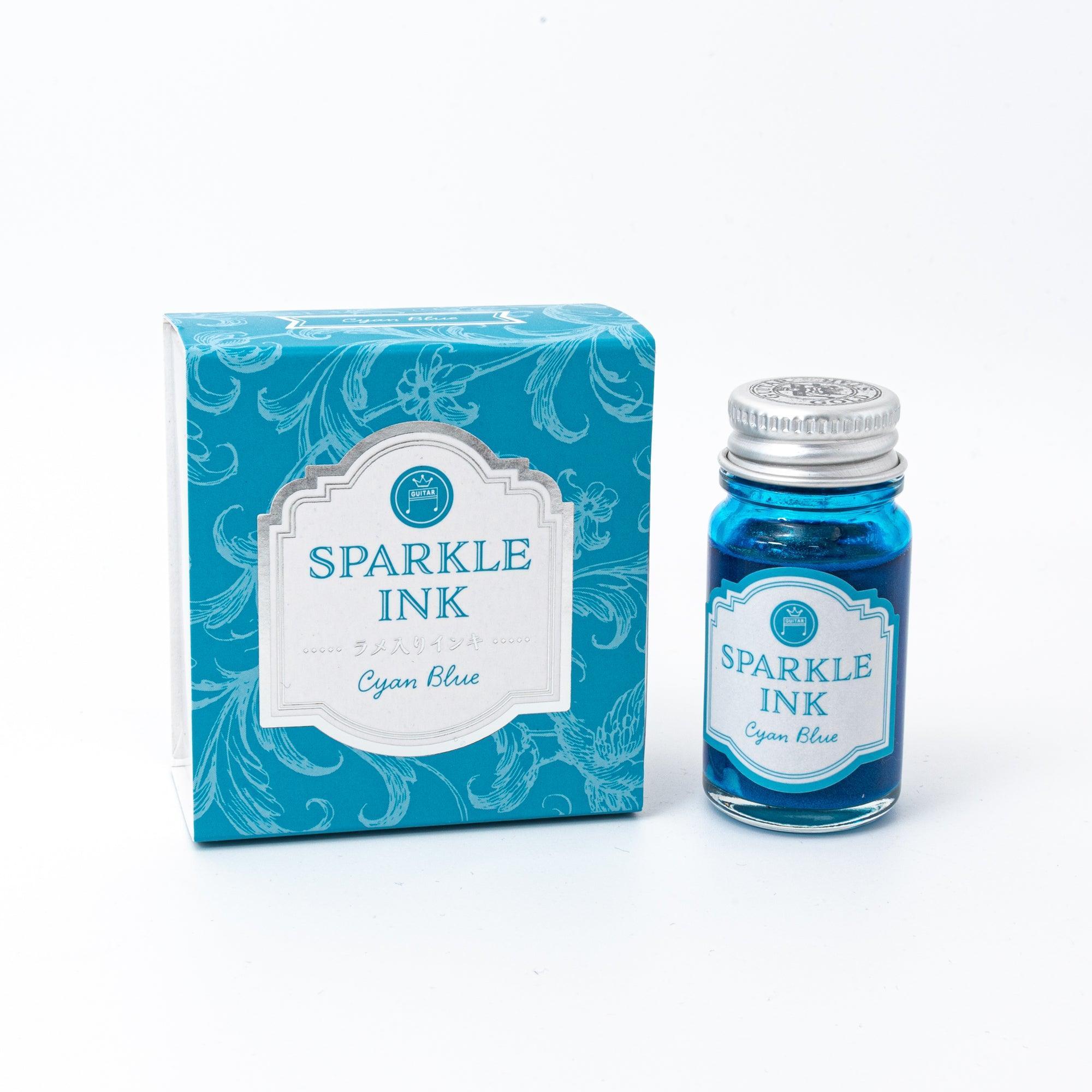 Sparkle Ink in Cyan Blue, displayed in a glass bottle with matching cyan packaging featuring floral patterns and elegant lettering.