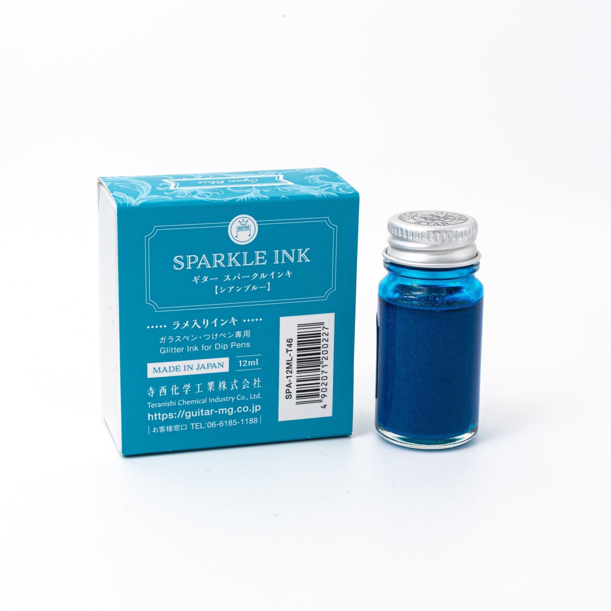 Sparkle Ink in Cyan Blue, displayed in a glass bottle with matching cyan packaging featuring floral patterns and elegant lettering.