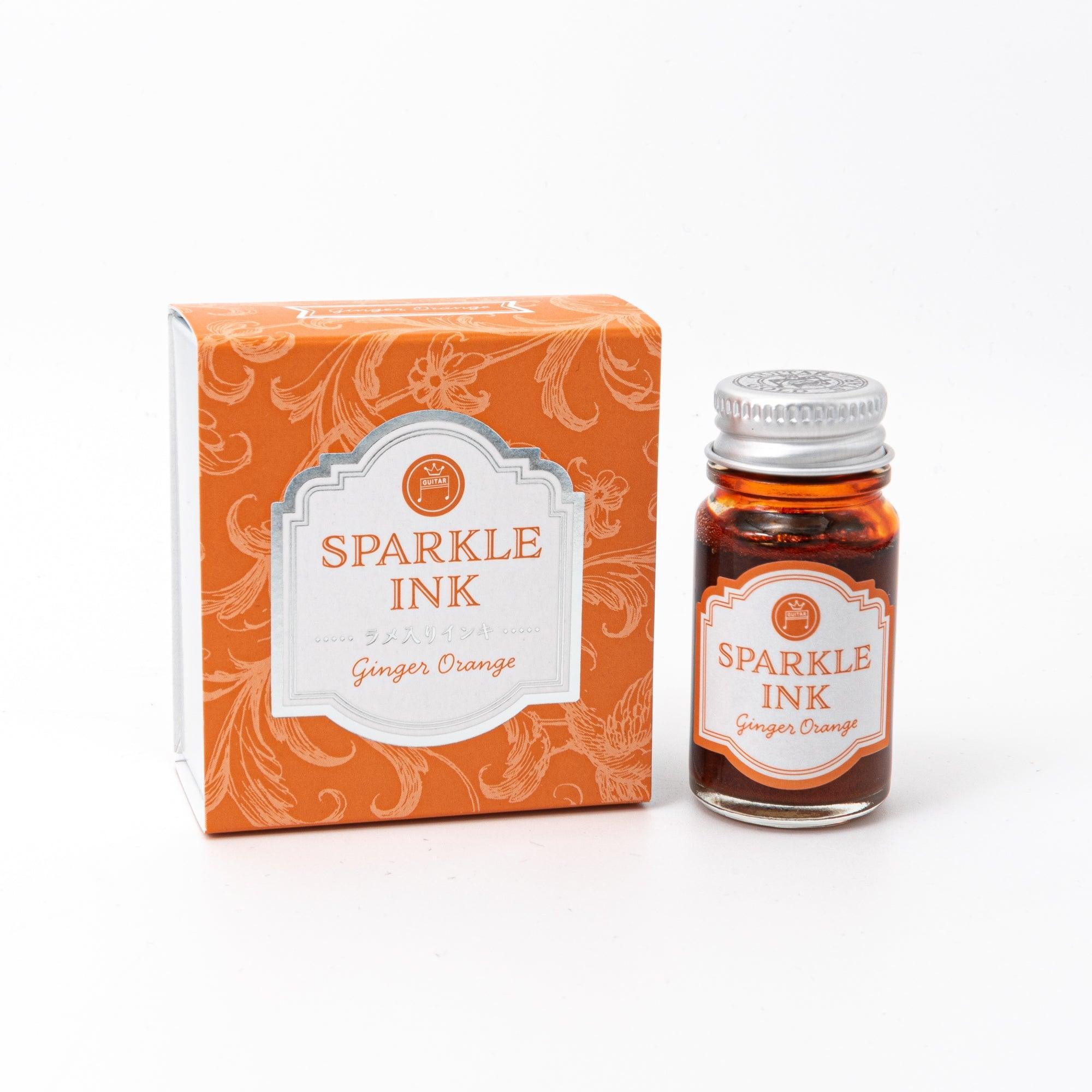 Sparkle Ink in Ginger Orange, displayed in a glass bottle with matching orange packaging featuring floral patterns and elegant lettering.