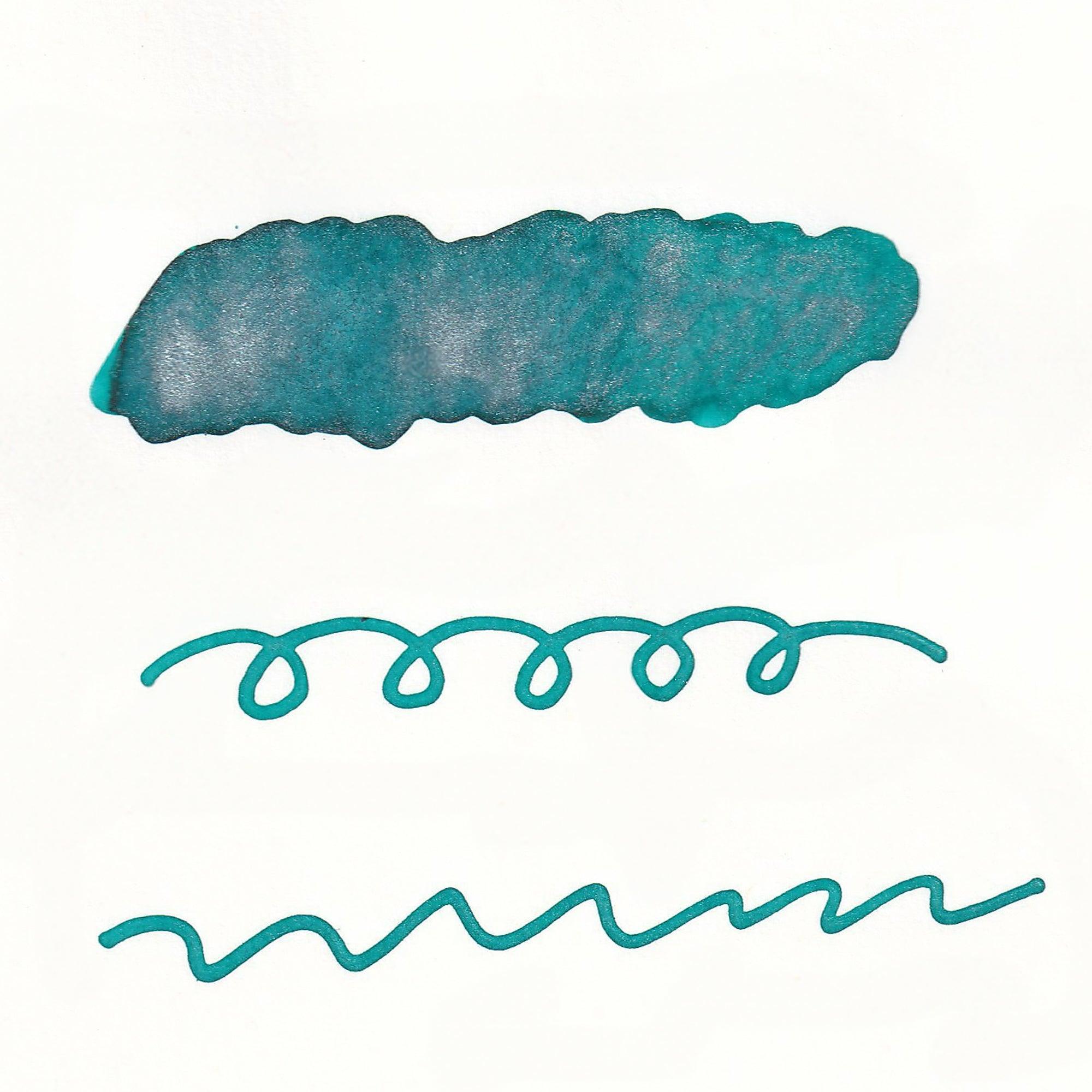 Swatches of Sparkle Ink in Mermaid Green, displaying vibrant green hues with shimmering effects, shown as lines and a solid stroke on white paper.