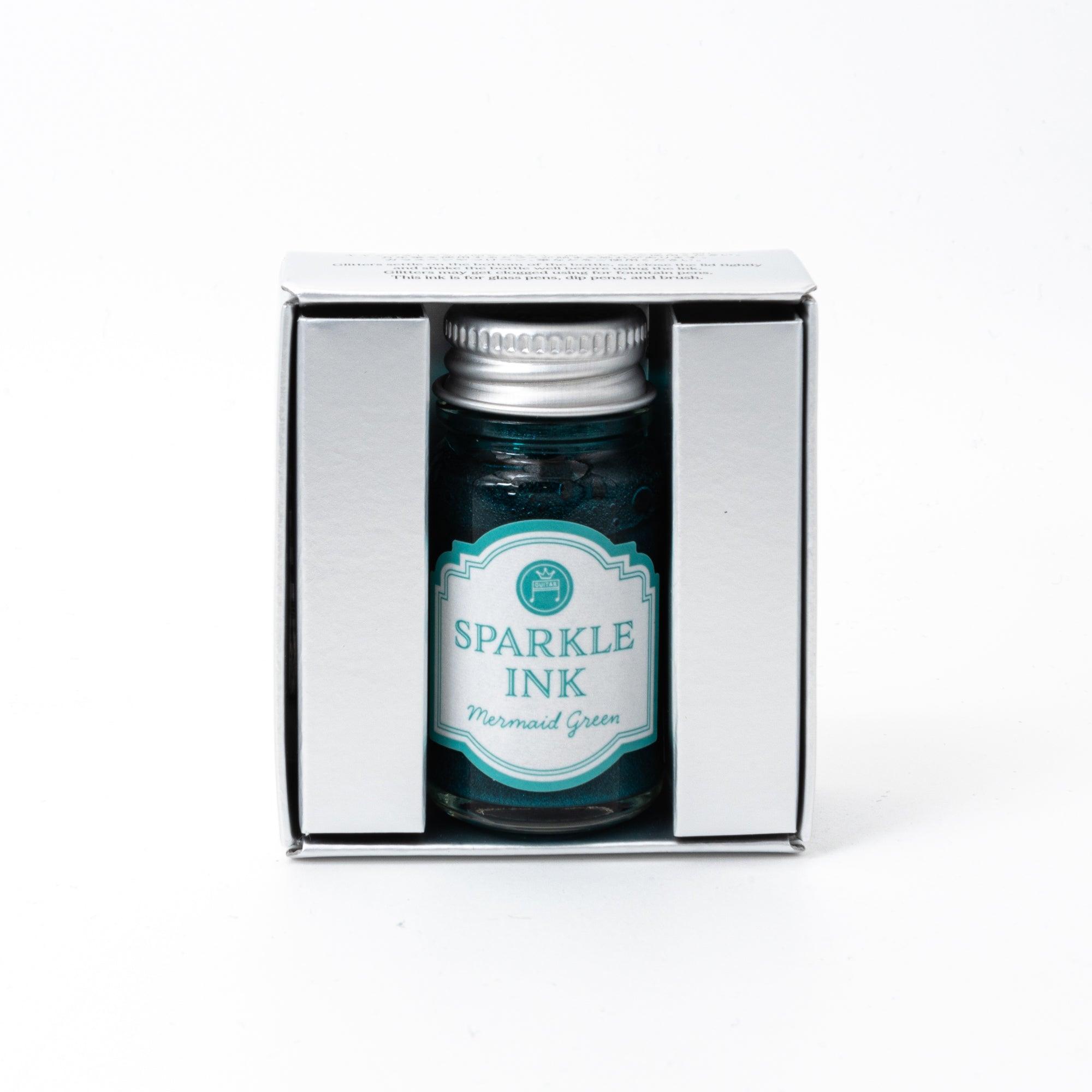 Sparkle Ink in Mermaid Green, presented in a glass bottle with coordinating green packaging featuring ornate floral patterns and