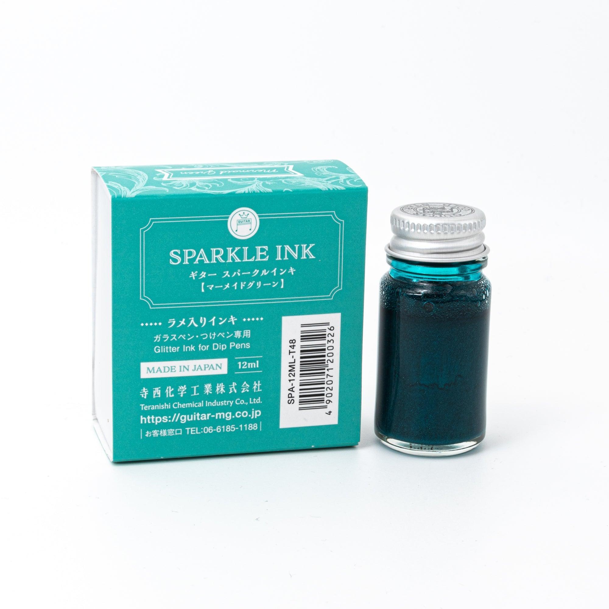 Sparkle Ink in Mermaid Green, presented in a glass bottle with coordinating green packaging featuring ornate floral patterns and