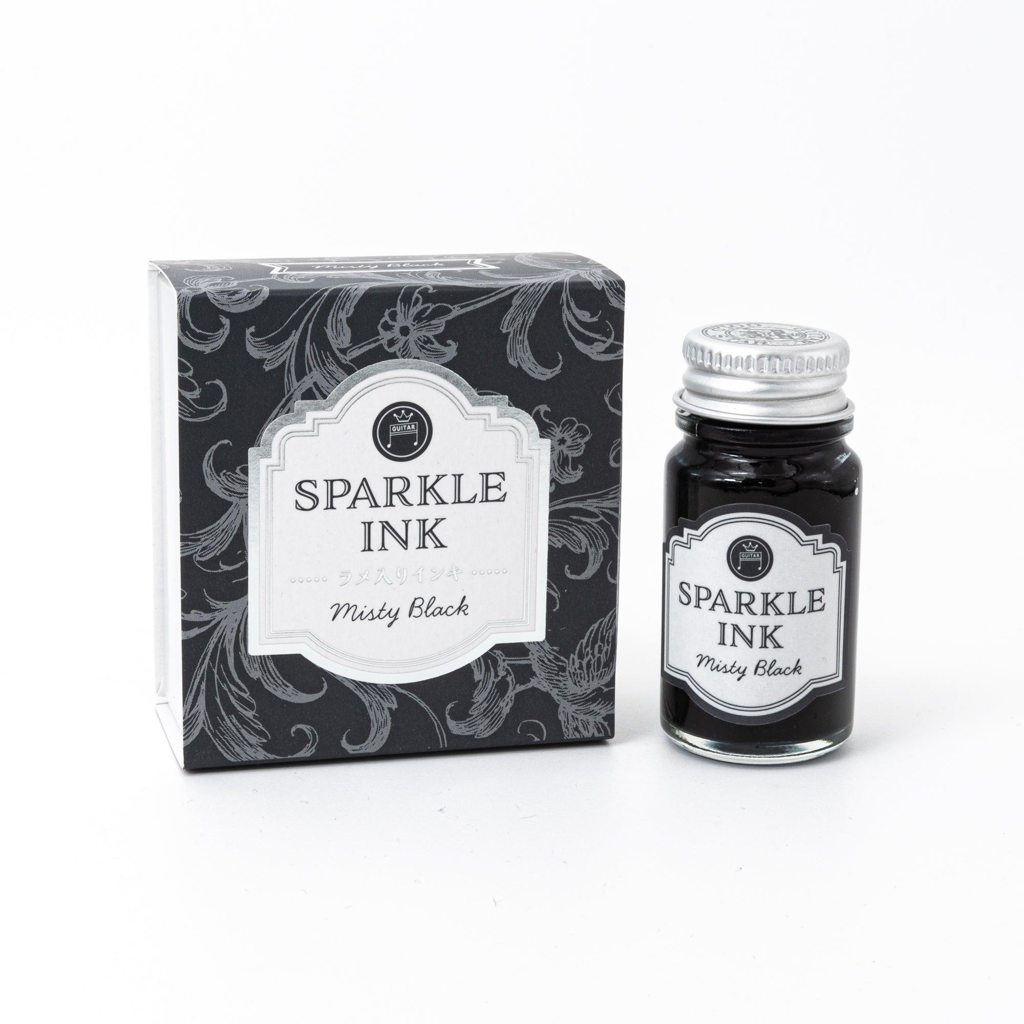 A bottle of Sparkle Ink in Misty Black, paired with its matching decorative box, featuring elegant floral patterns in monochrome design.