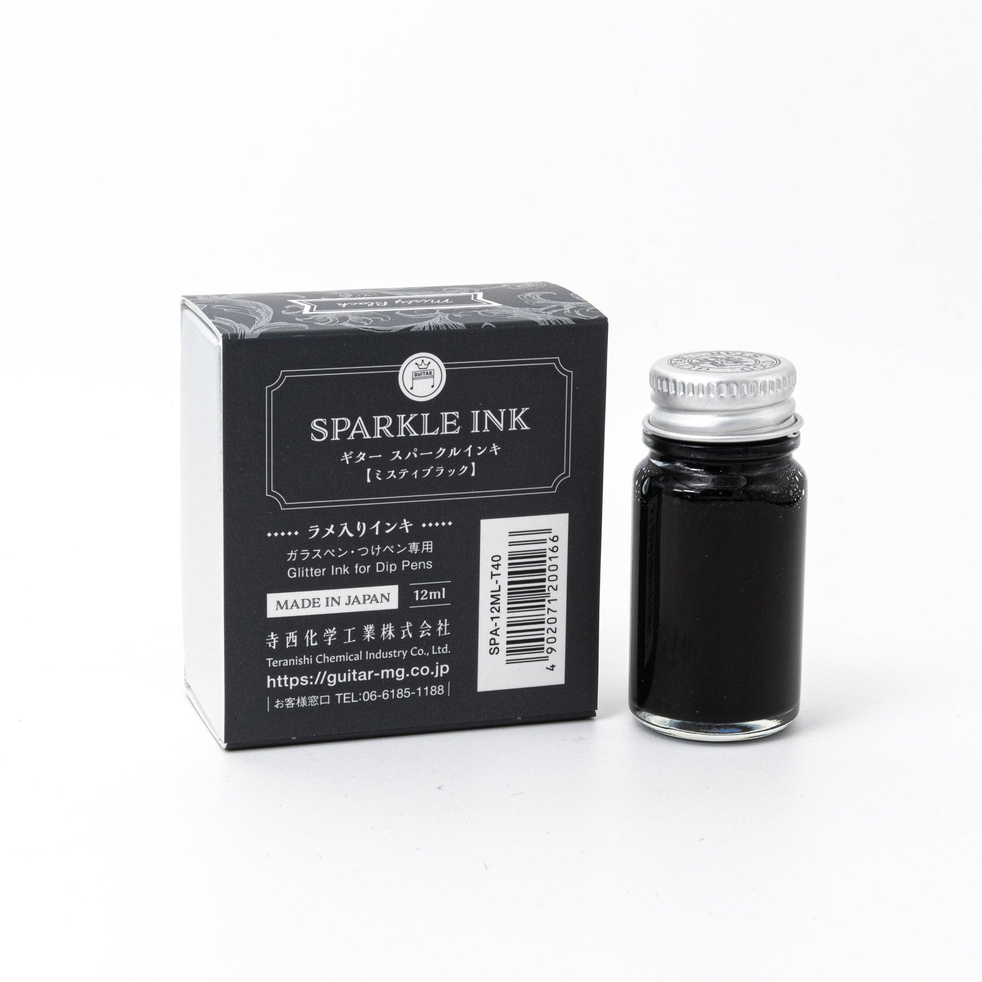 A bottle of Sparkle Ink in Misty Black, paired with its matching decorative box, featuring elegant floral patterns in monochrome design.
