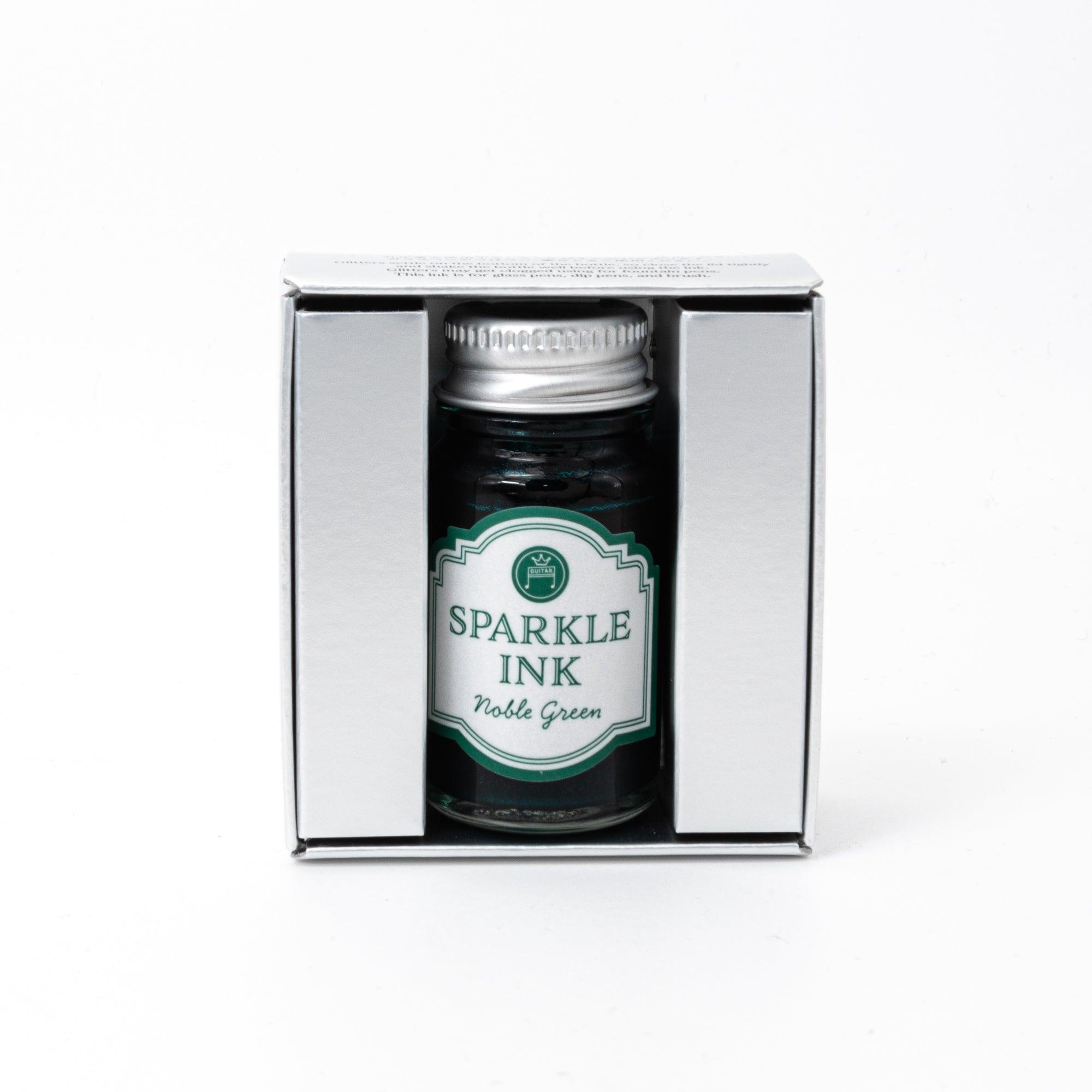 Sparkle Ink in Noble Green, presented in a glass bottle with elegant packaging adorned with floral patterns in matching green tones.