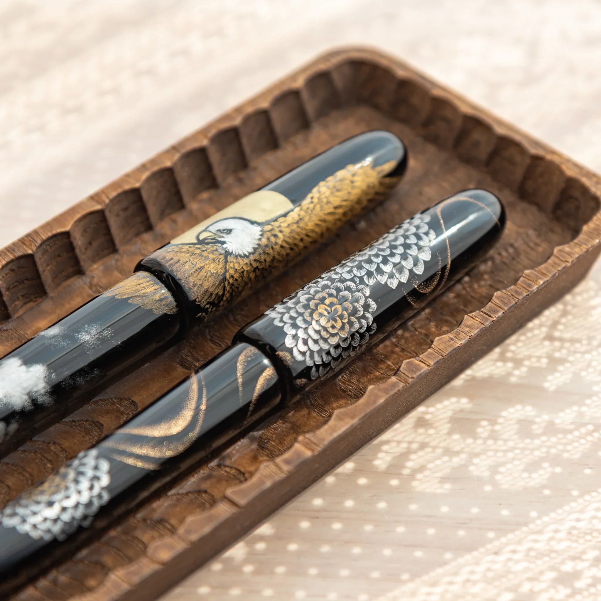 Pen tray detail showing traditional carving technique on light wood material displayed clearly composition