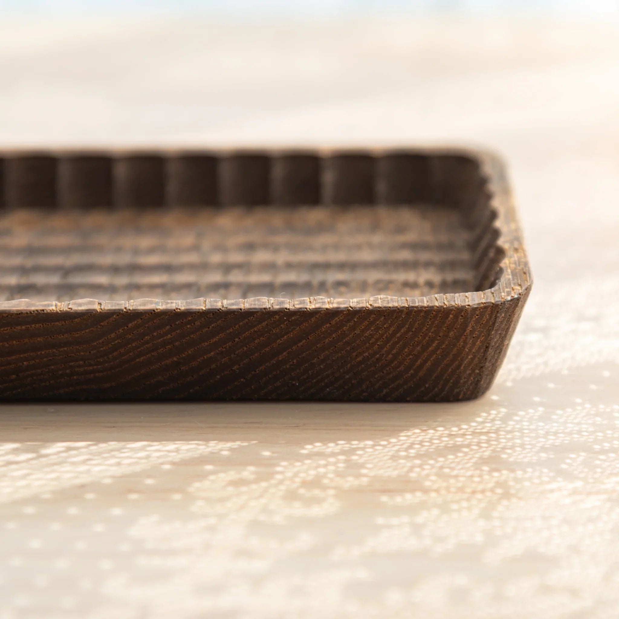Hand-carved wooden tray detail with visible craftsmanship and carving clearly visible with precise carving detail