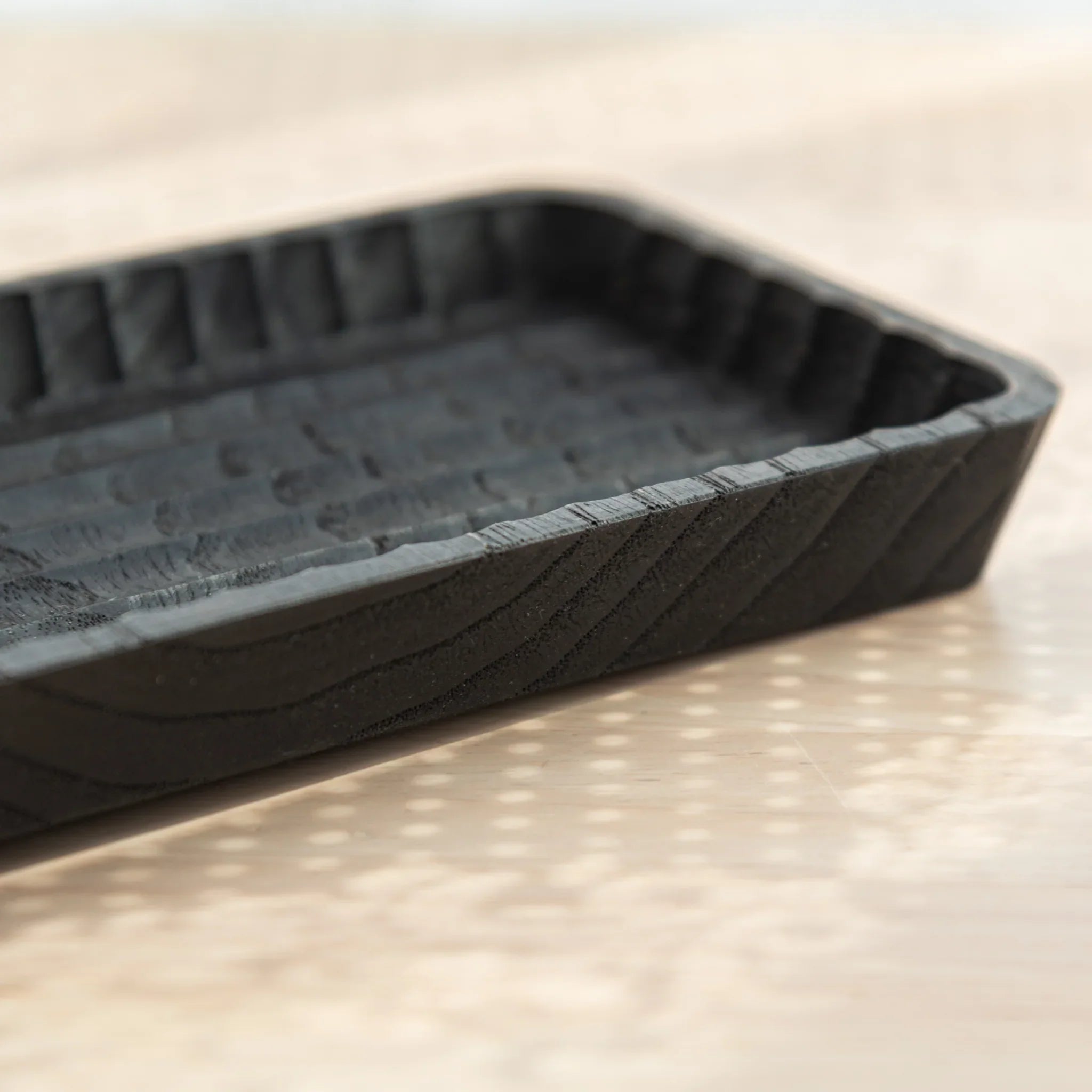 Slim wooden tray showing ridge pattern carving and detail composition clearly visible with ceramic finish