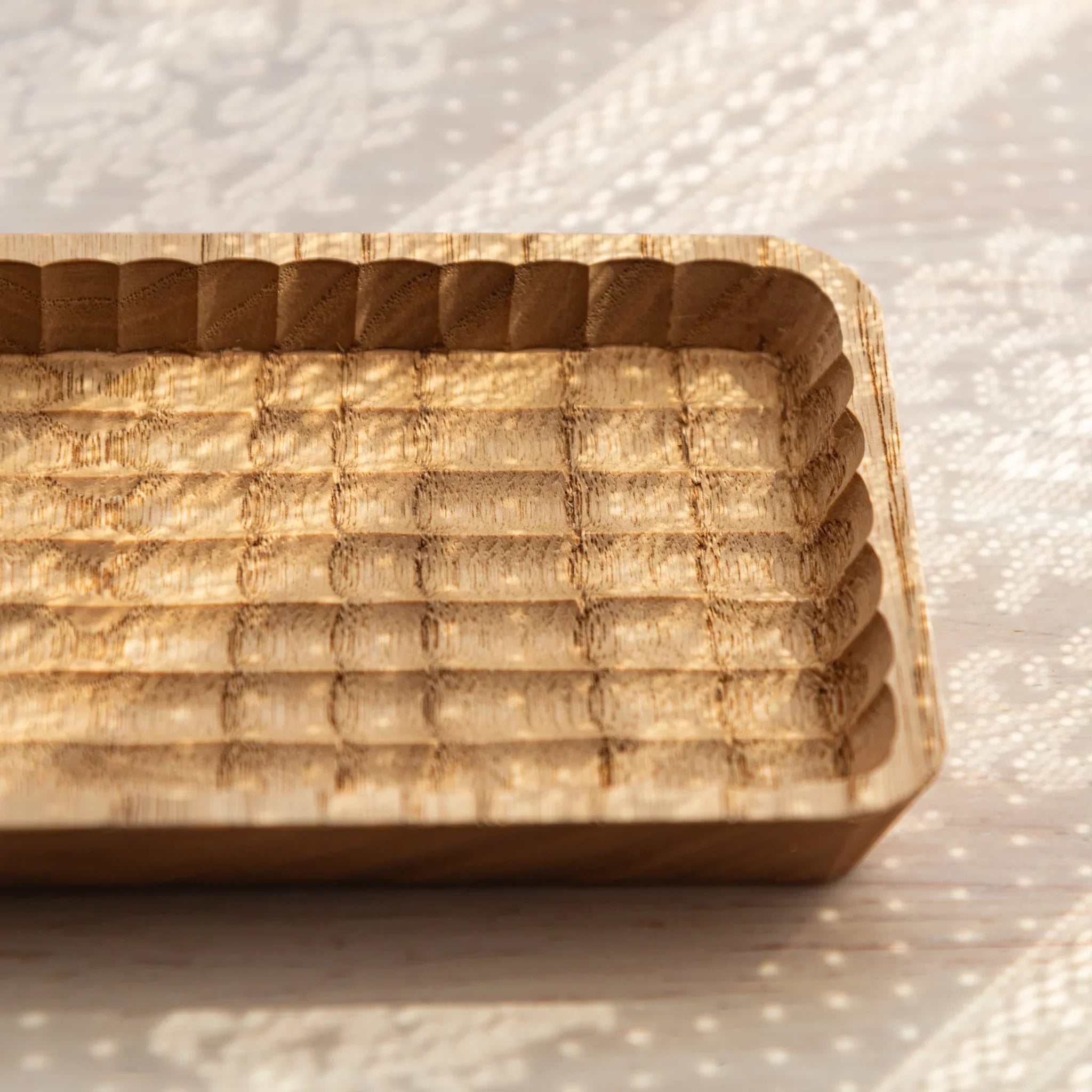 Wooden tray showing hand-carved parallel grooves for pen storage structure displayed clearly composition