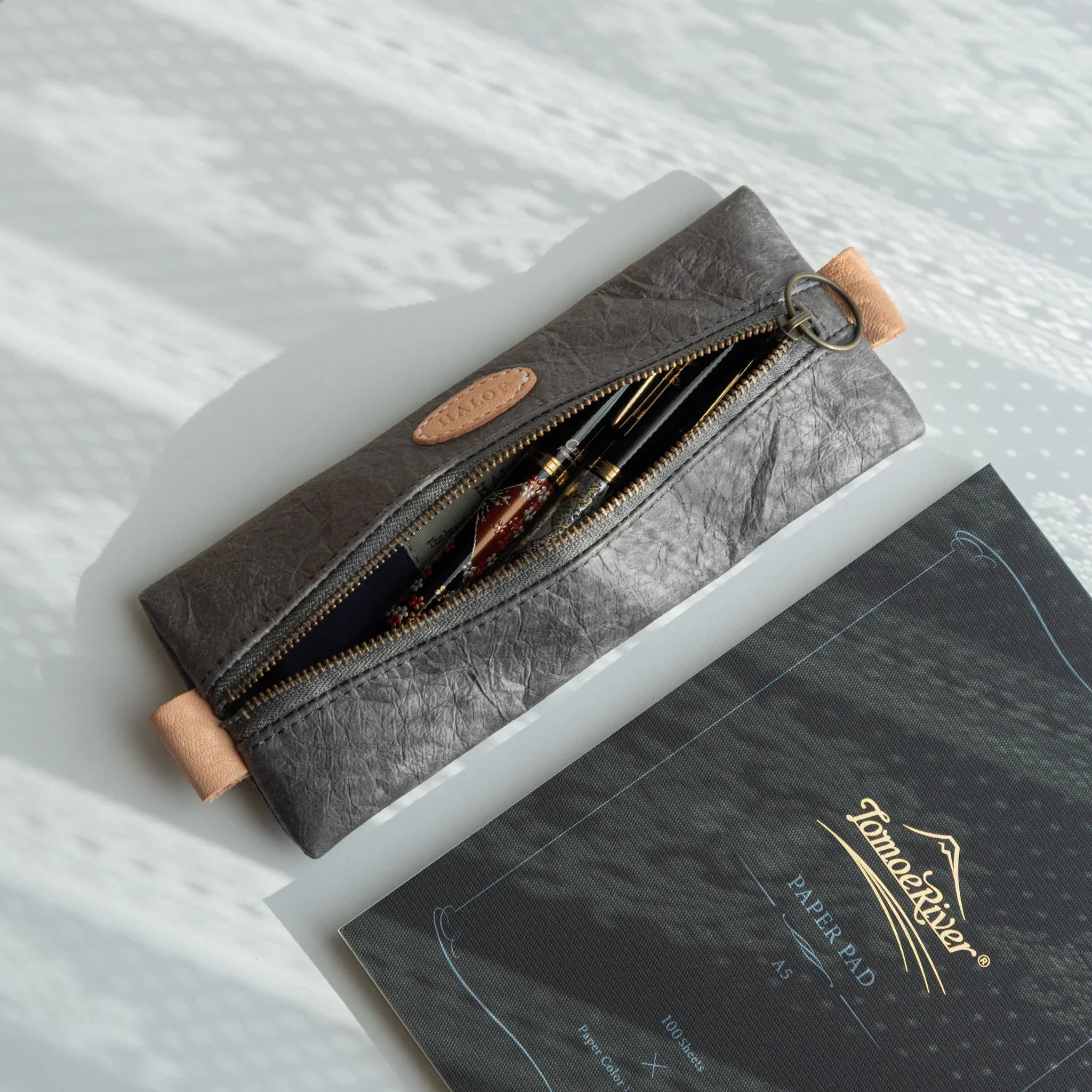 Gray pen case detail showing handcrafted washi paper construction method displayed clearly composition