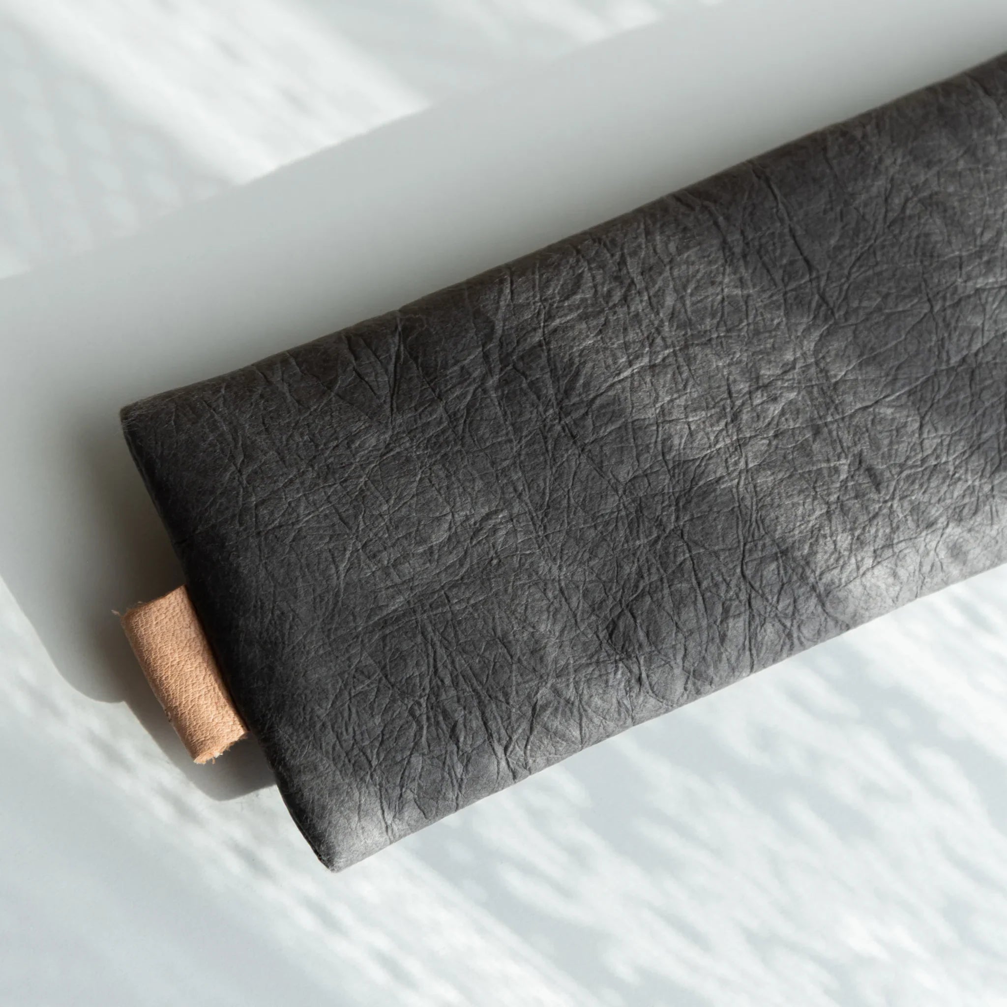 Handcrafted gray pen case showing interior structure and compartments displayed clearly with traditional construction