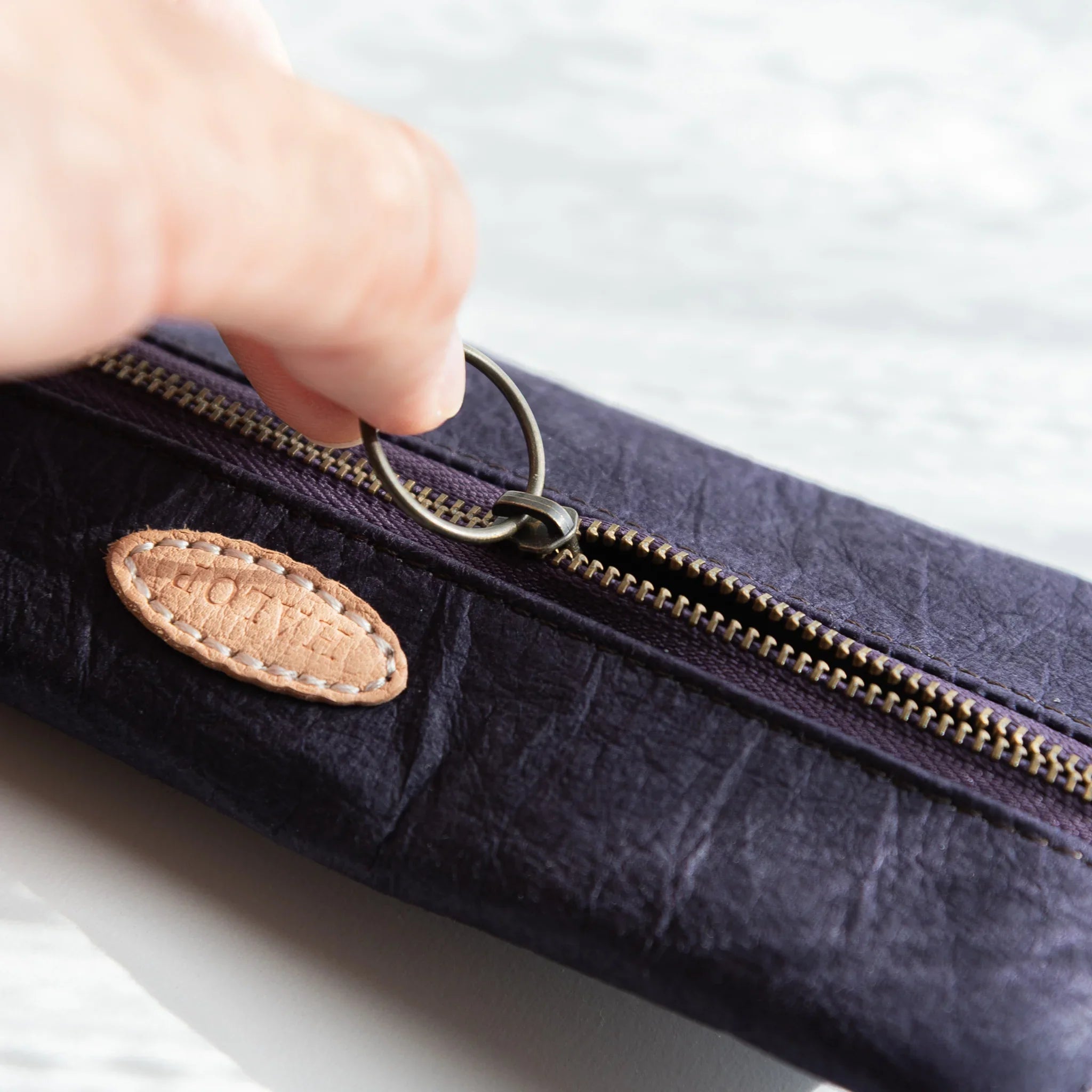 Sugihara washi pen case in purple tone with visible paper grain texture displayed clearly with hand-dyed finish