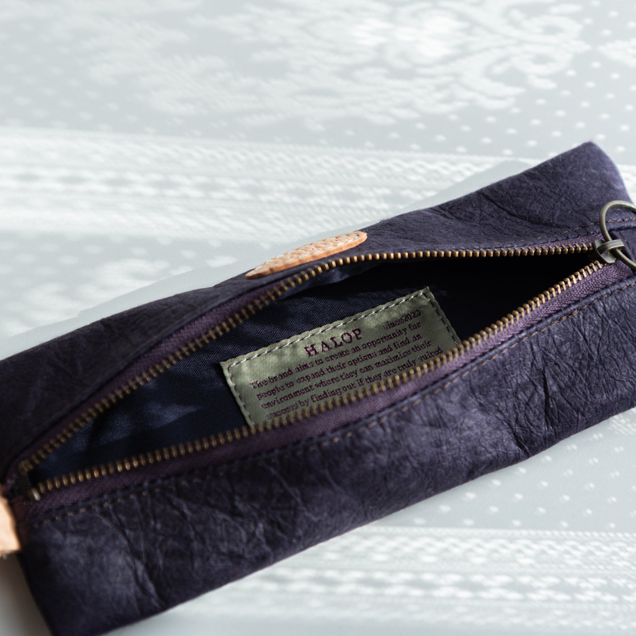 Washi paper case with Sugihara brand clearly visible on purple surface on roll with traditional construction