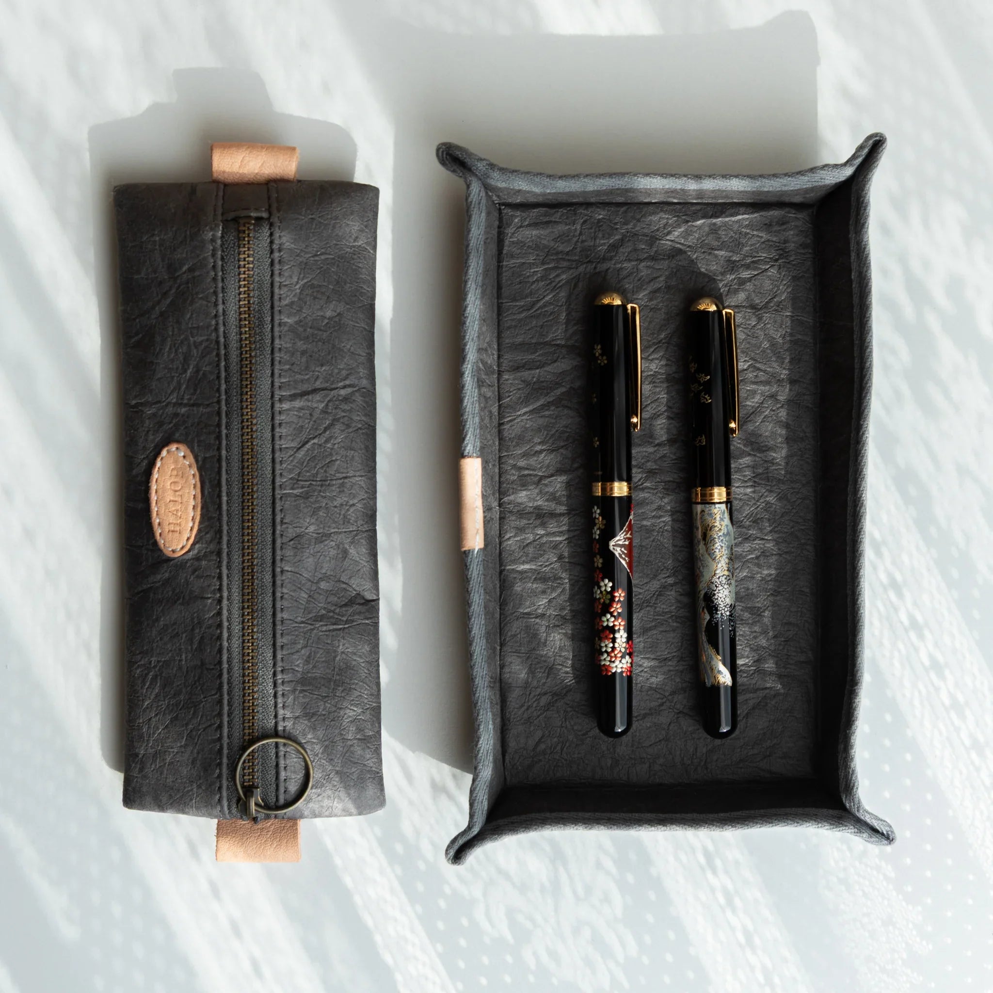 Japanese Pen Tray – Grey displayed beside a matching washi pen case, holding two lacquered Japanese Fountain Pens.