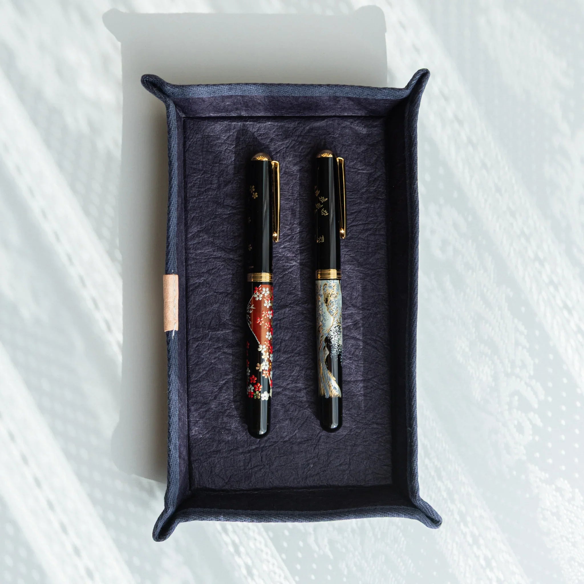 Japanese Pen Tray – Purple holding two lacquered Japanese Fountain Pens, combining refined craft and elegant functionality.