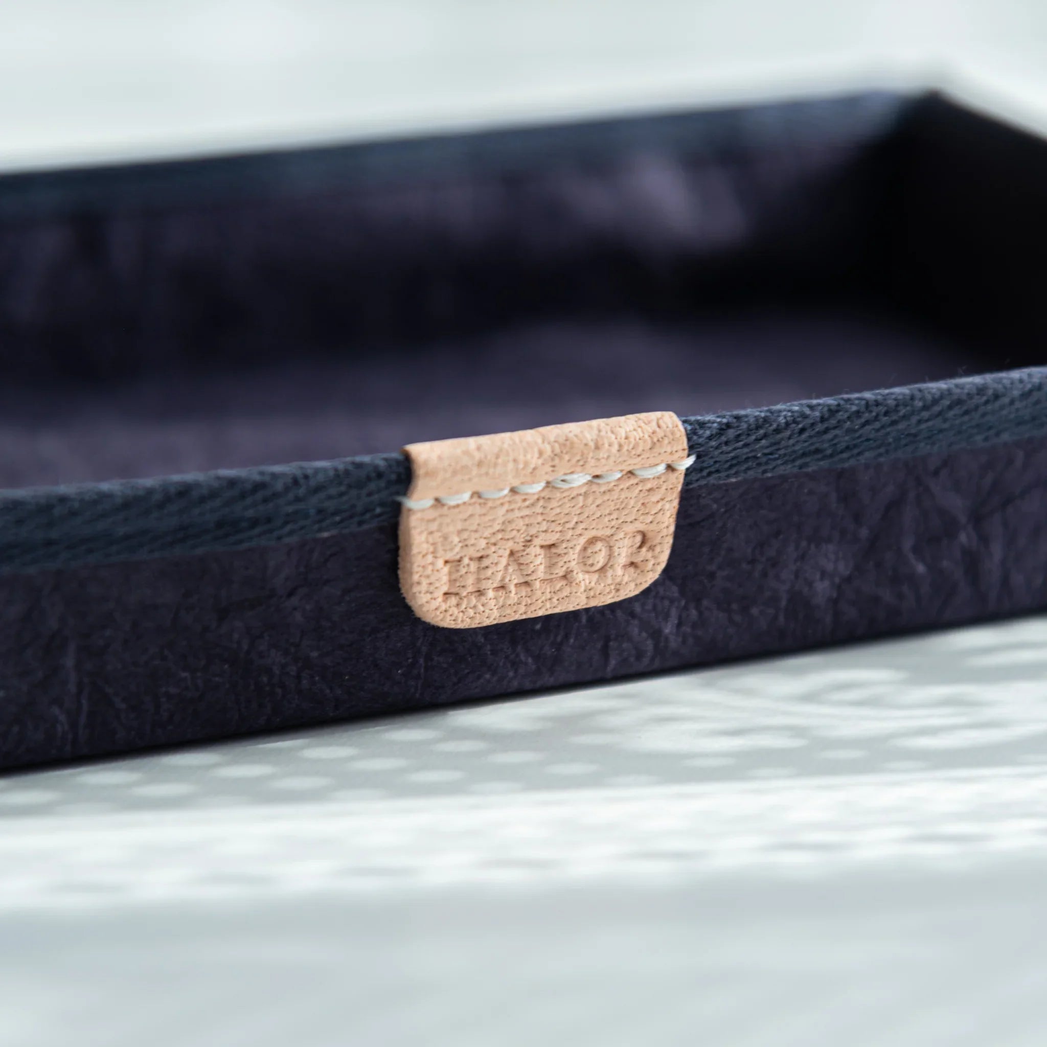 Close-up of natural leather tag with HALOP logo on the purple Japanese Pen Tray, blending modern design and tradition.