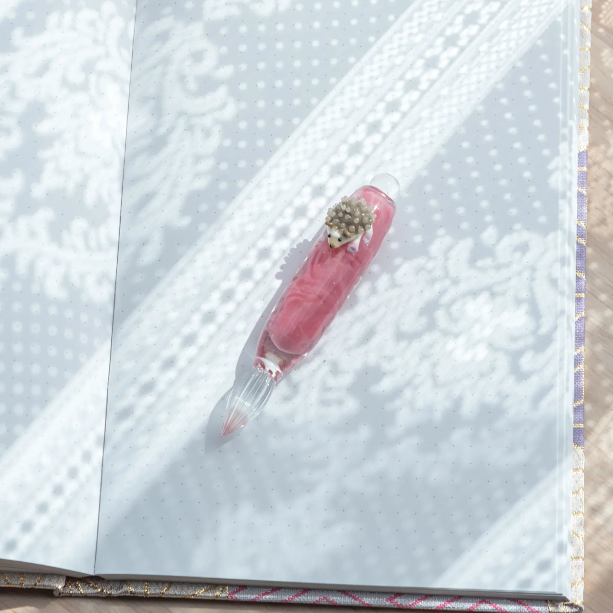 Whimsical hedgehog glass dip pen featuring cute spiky creature ideal for unique stationery collections