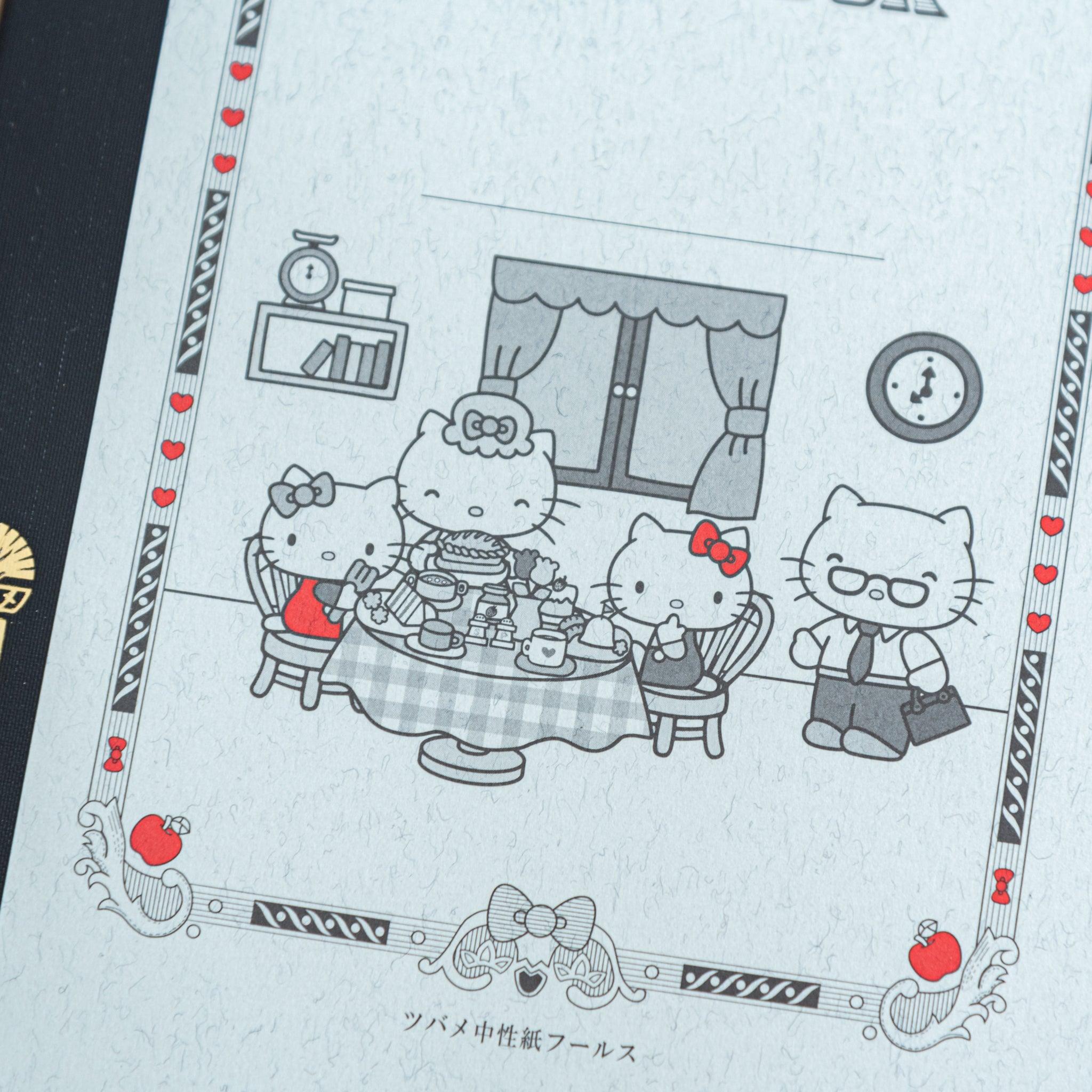 A detailed view of the Tsubame Japanese notebook’s Hello Kitty illustration, depicting a family tea party with red accents, combining elegance with playful Japanese stationery.