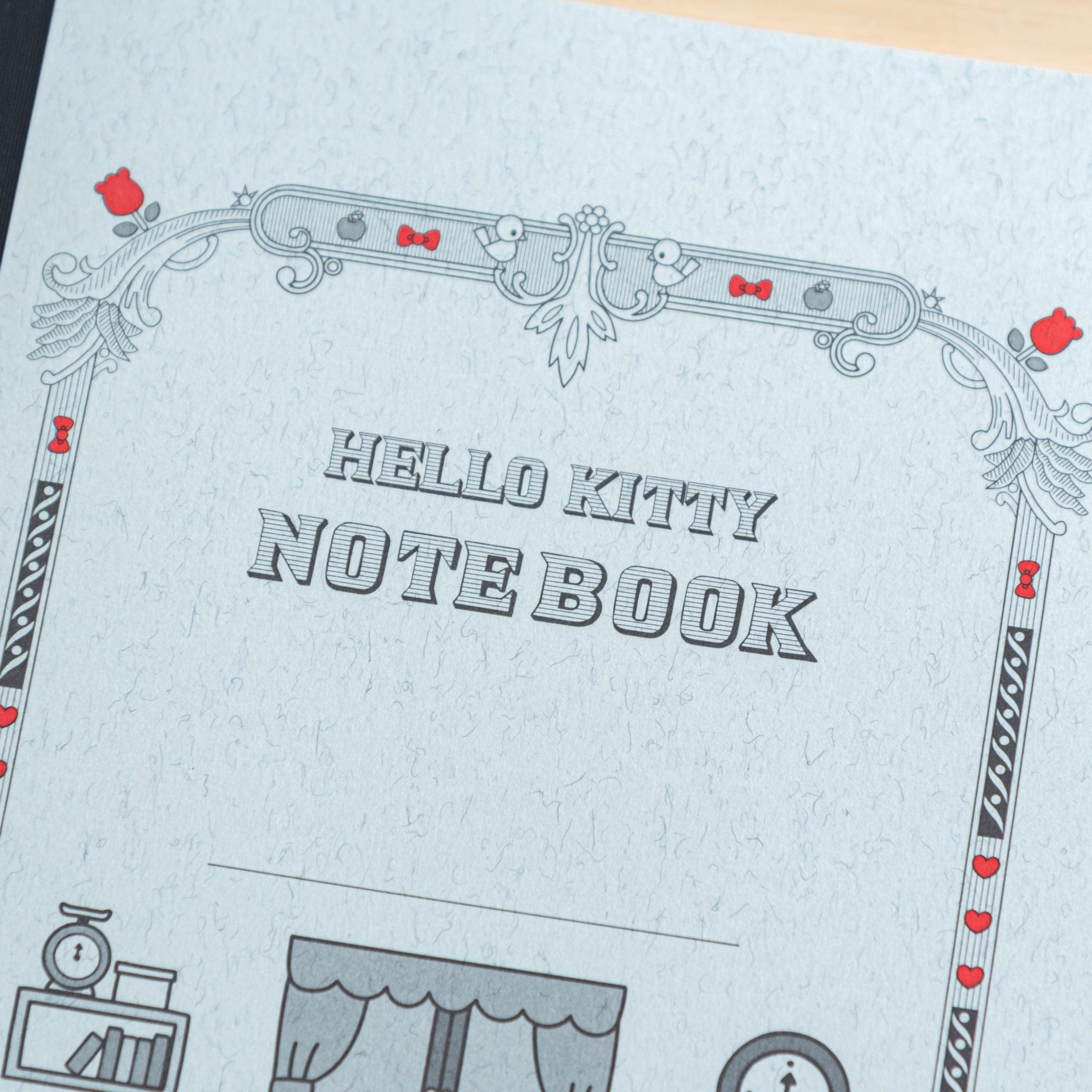 A close-up of the Tsubame Japanese notebook’s cover, showcasing "HELLO KITTY NOTEBOOK" in bold letters with intricate black and red decorative elements.