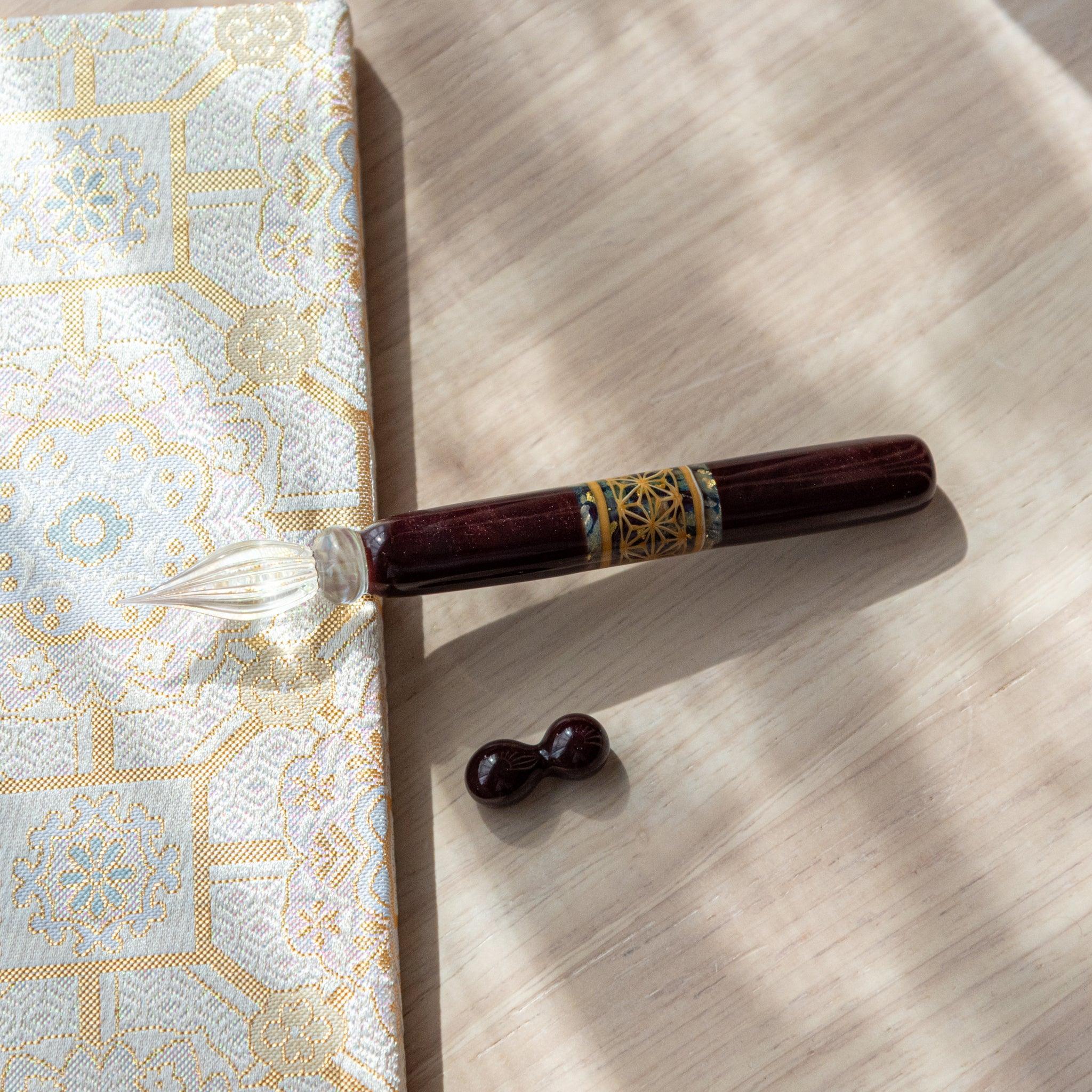 Display of hemp leaves glass dip pen showing traditional asanoha hemp pattern design on transparent glass barrel