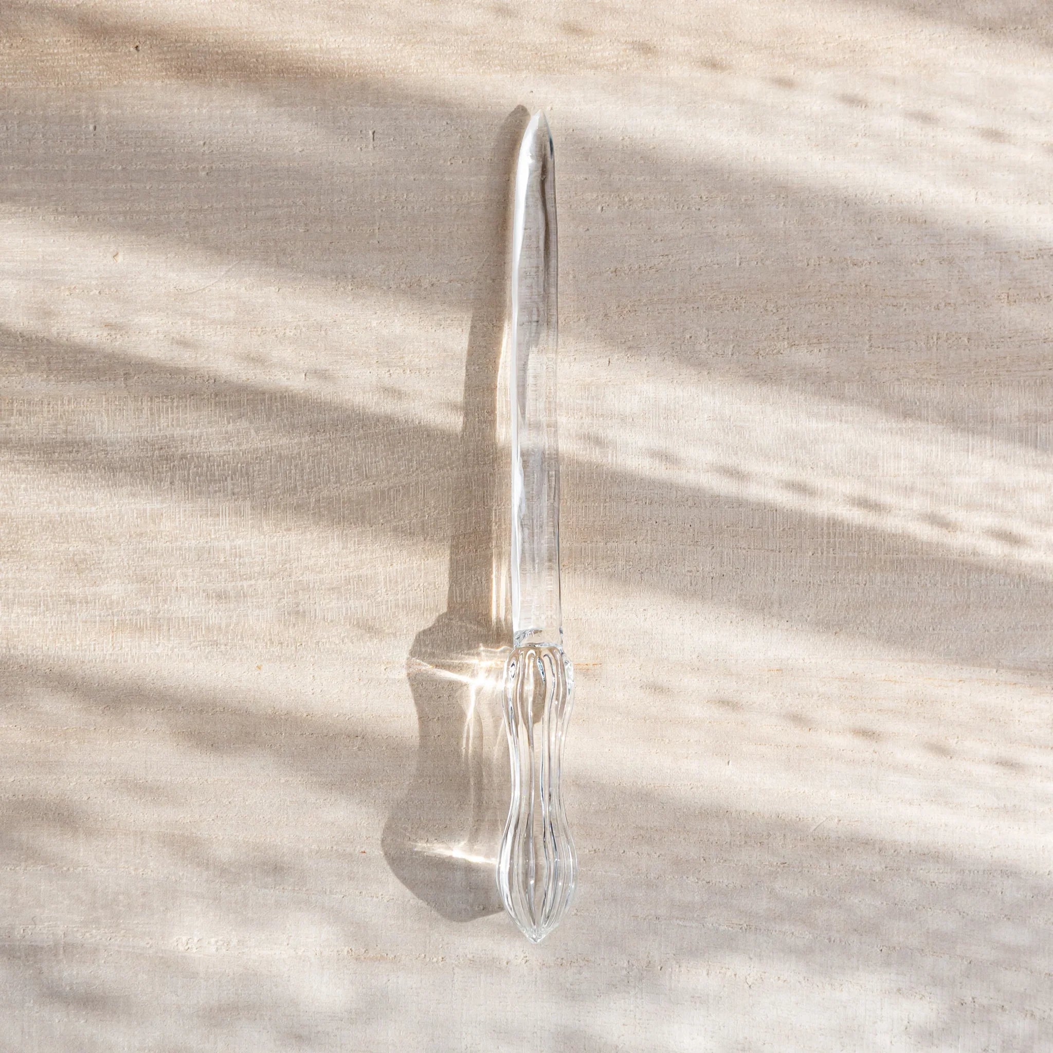 Hikari glass letter opener with clear glass shown in composition detail shown in composition product composition view