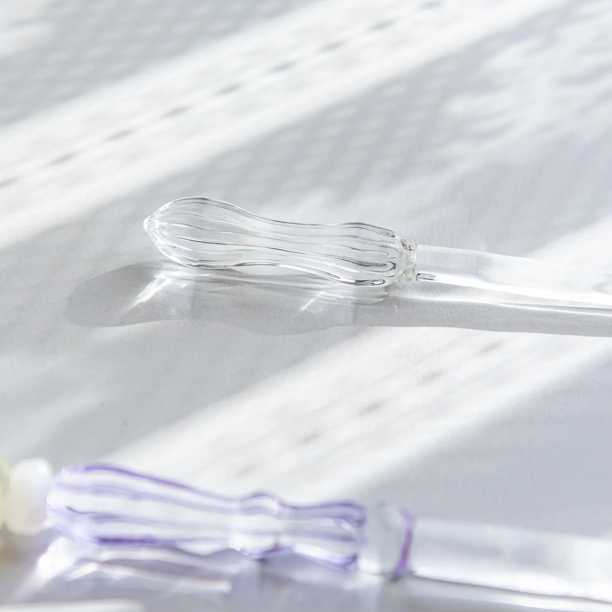 Hikari glass letter opener with clear glass shown in composition detail shown view composition product composition view