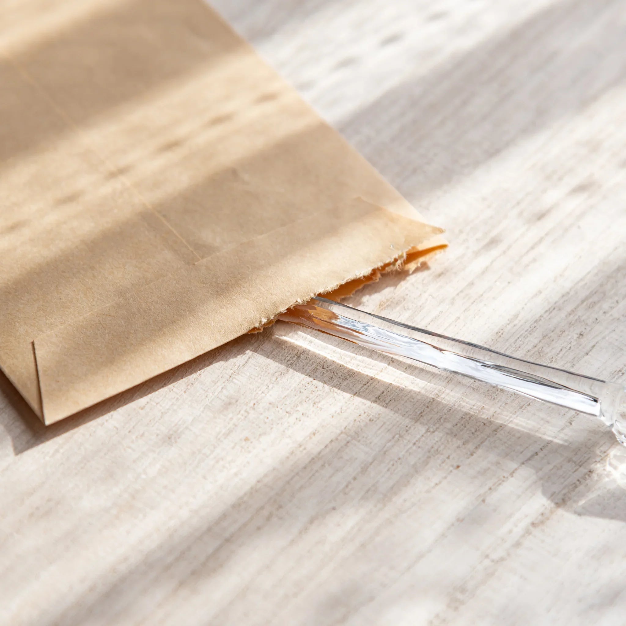 Hikari glass letter opener with clear glass shown in composition detail displayed in composition product composition view