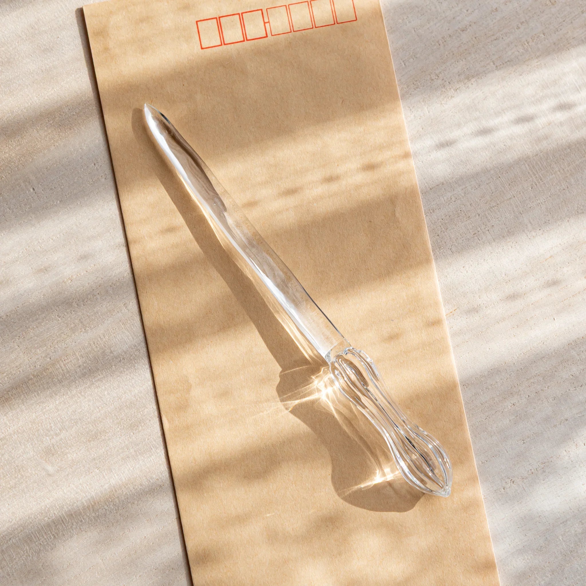 Hikari glass letter opener with clear glass shown in composition detail displayed in detail product composition view