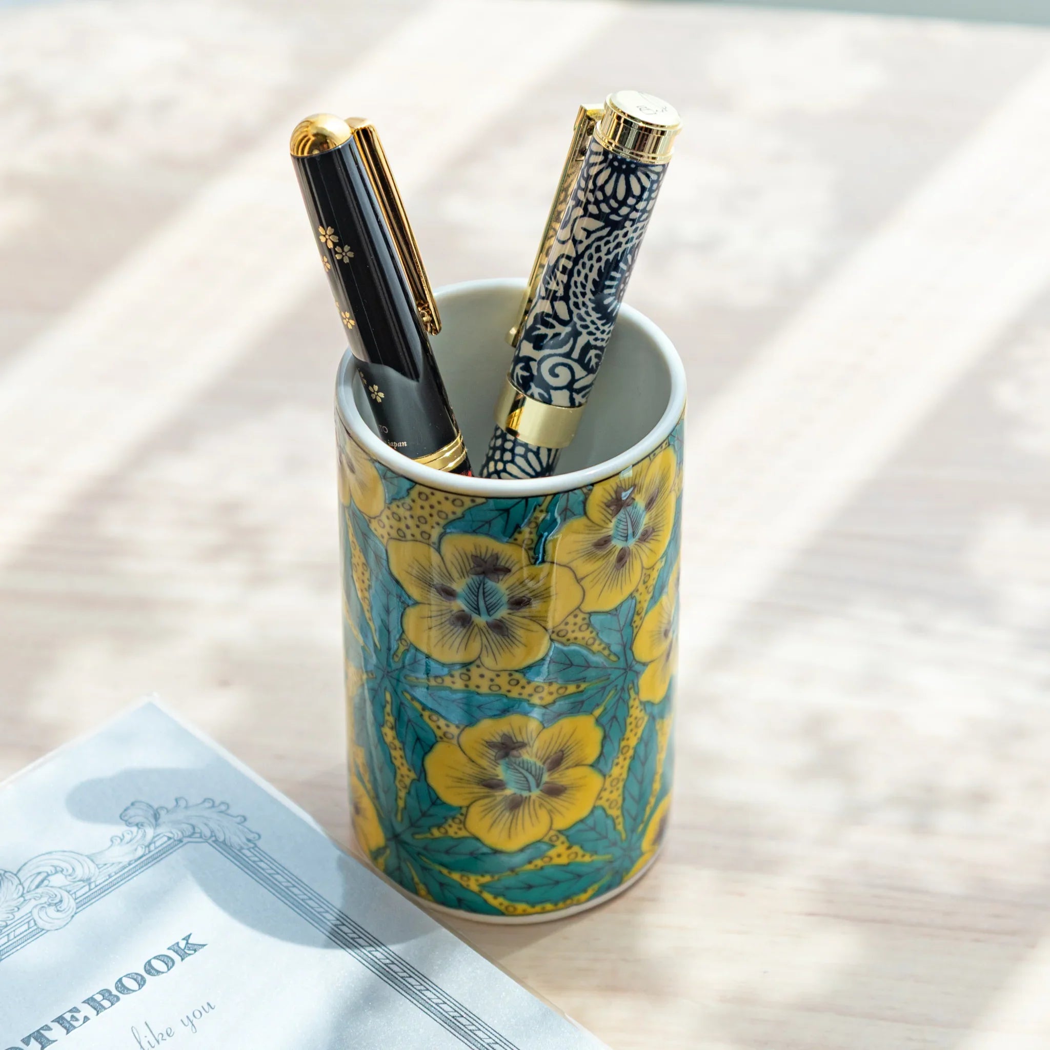 Decorative Kutani ceramic pen holder with vibrant hollyhock flower pattern for desk storage featuring traditional