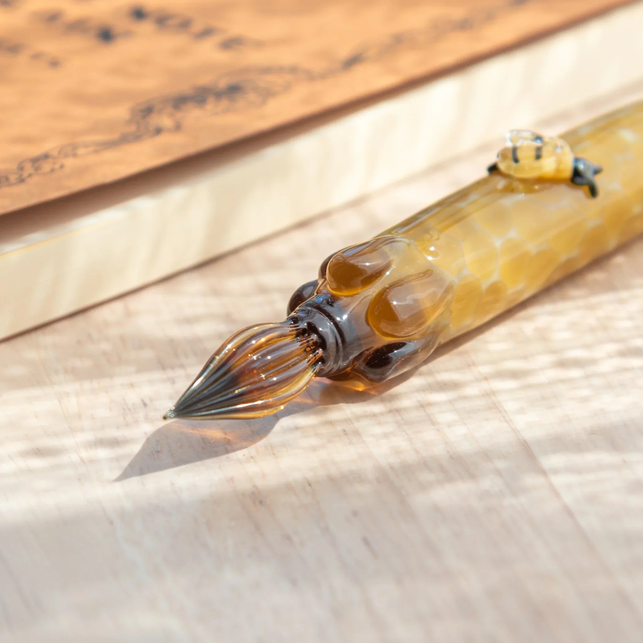 Artistic honey bee glass dip pen showcasing detailed resin bee craft and hand-blown glass components