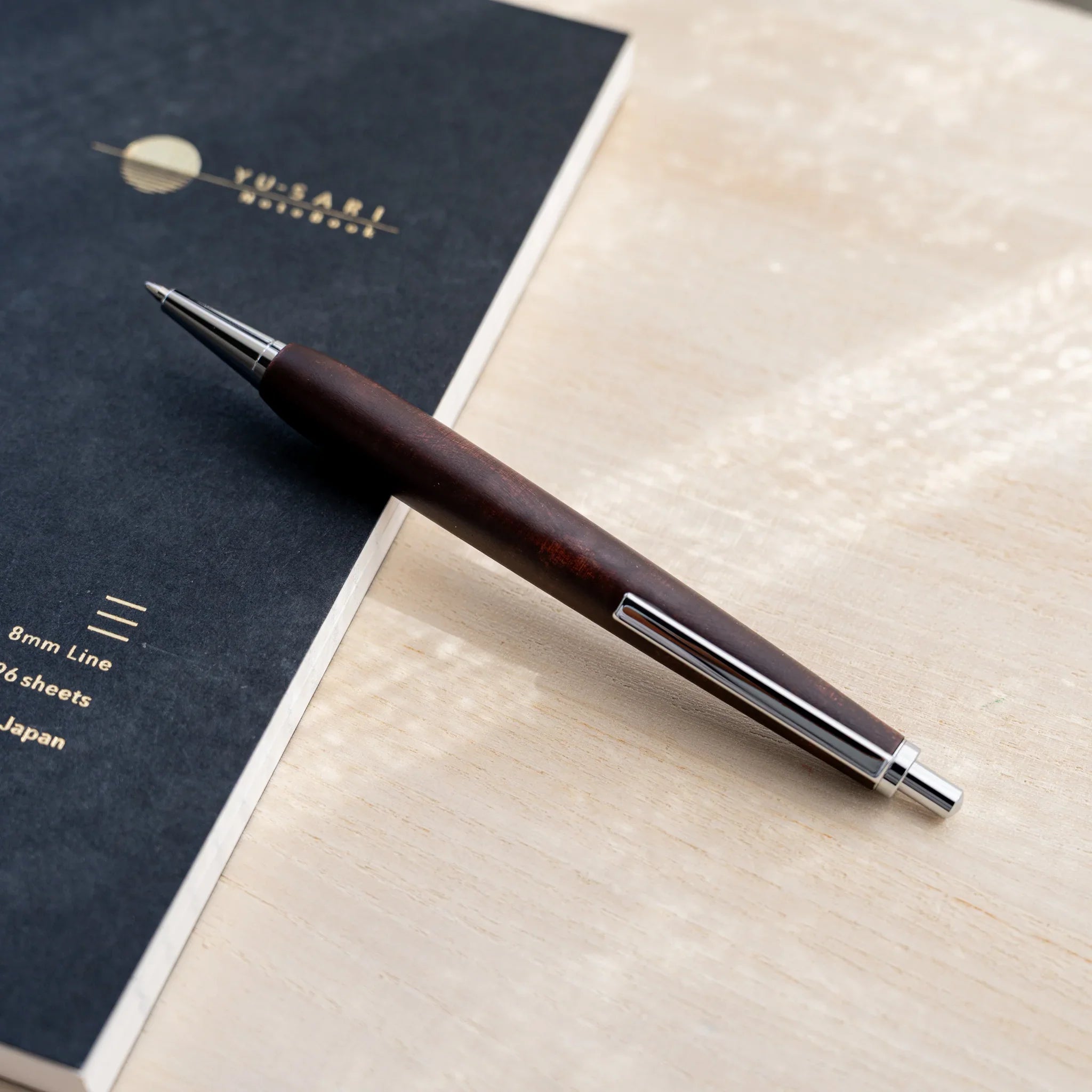 Horse chestnut wood urushi lacquered ballpoint pen in chocolate brown, Japanese wood, angled full-body view