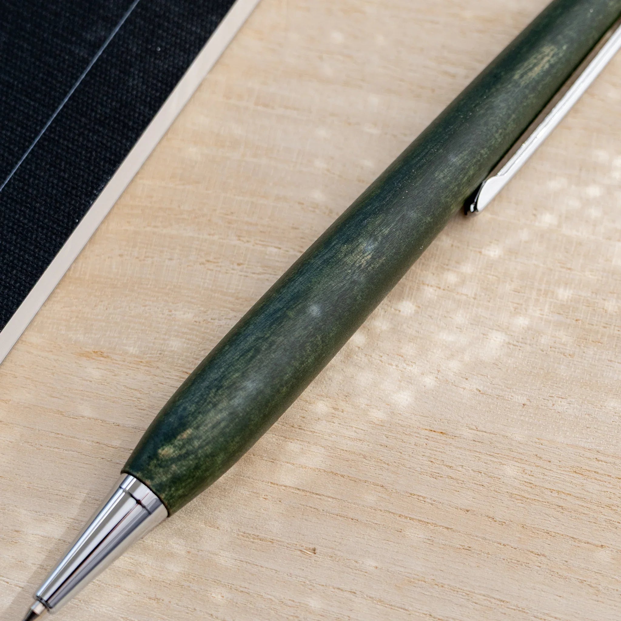 Horse chestnut wood urushi lacquered ballpoint pen in olive green, Japanese wood, full-body view
