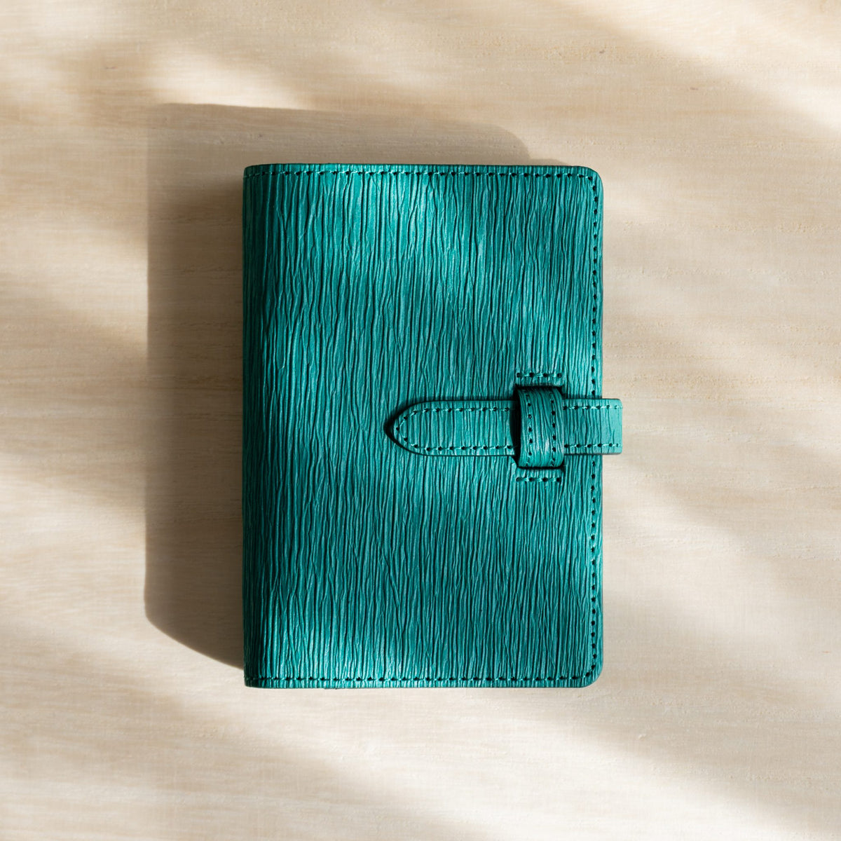 Ise Gikakushi paper leather planner, M5 size in teal, front cover with crease texture and strap