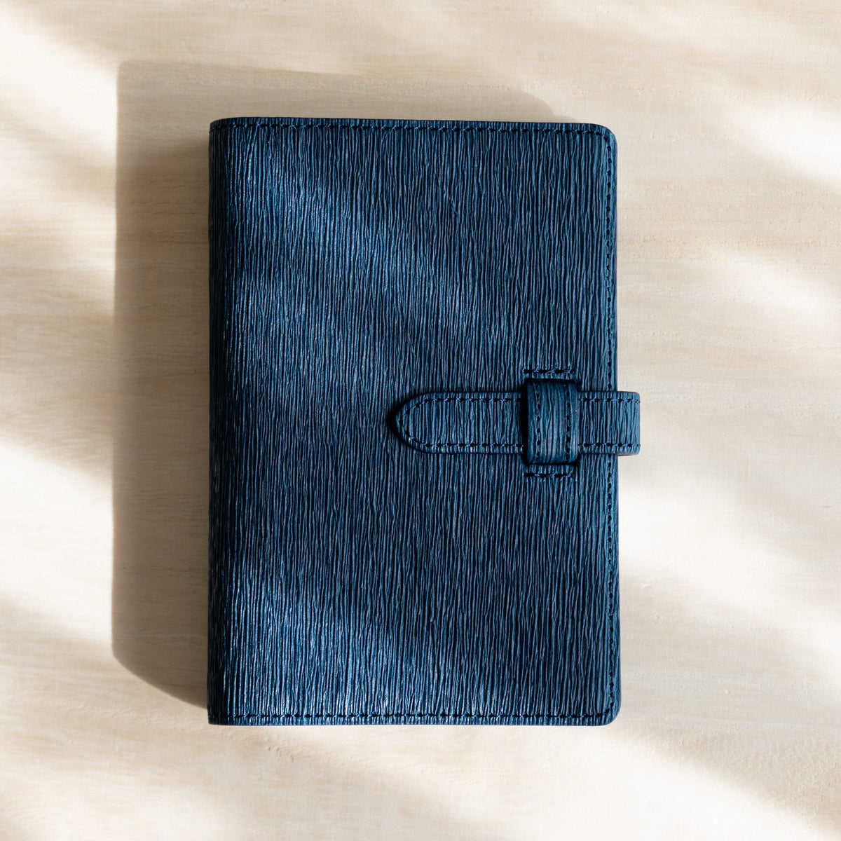Ise Gikakushi paper leather planner, Mini 6 size in navy, front cover with creases and strap